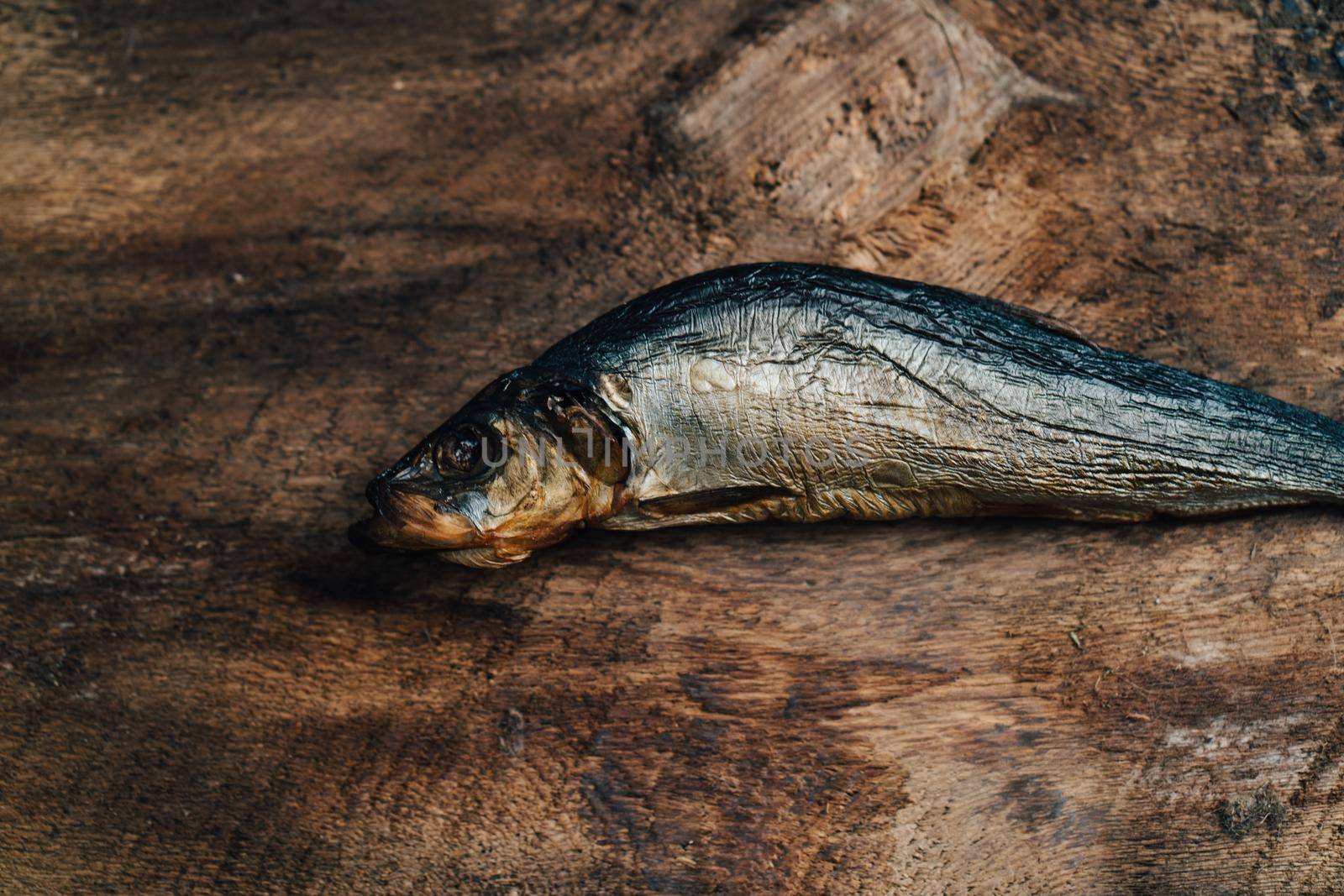 dried fish lies on a wooden table top view texture background image. High quality photo