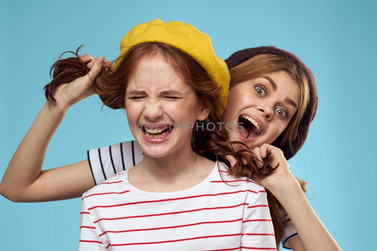 funny mom and daughter fashion studio lifestyle fun blue background family. High quality photo
