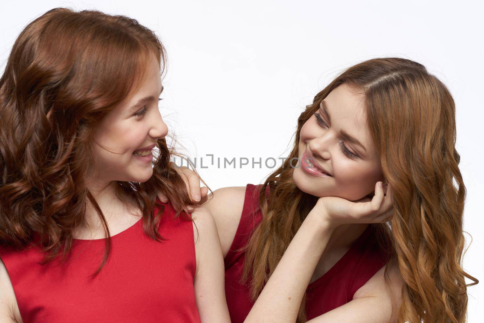 Cheerful mom and daughter hugs joy lifestyle family light background. High quality photo