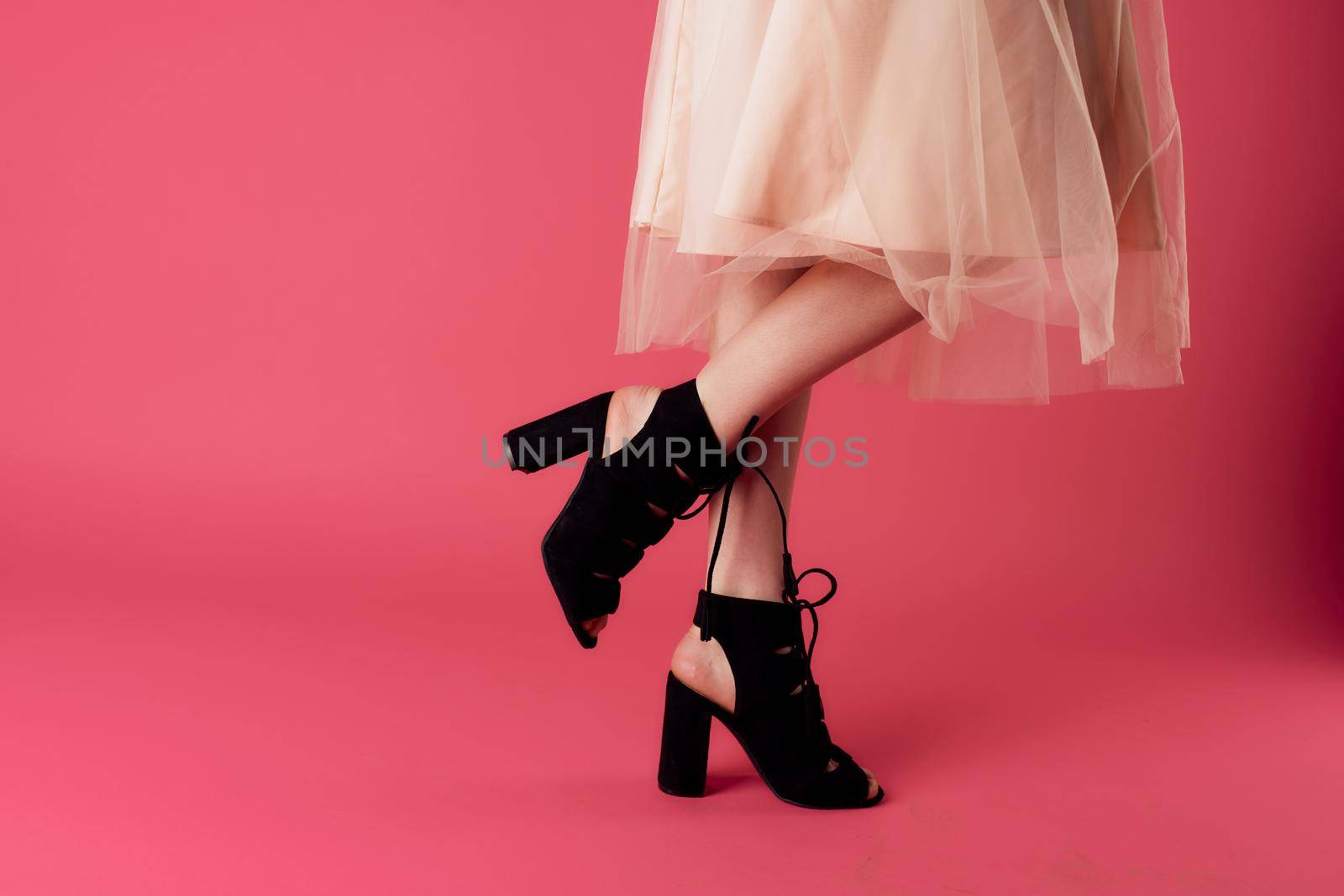 Womens feet fashionable shoes charm pink background shopping. High quality photo