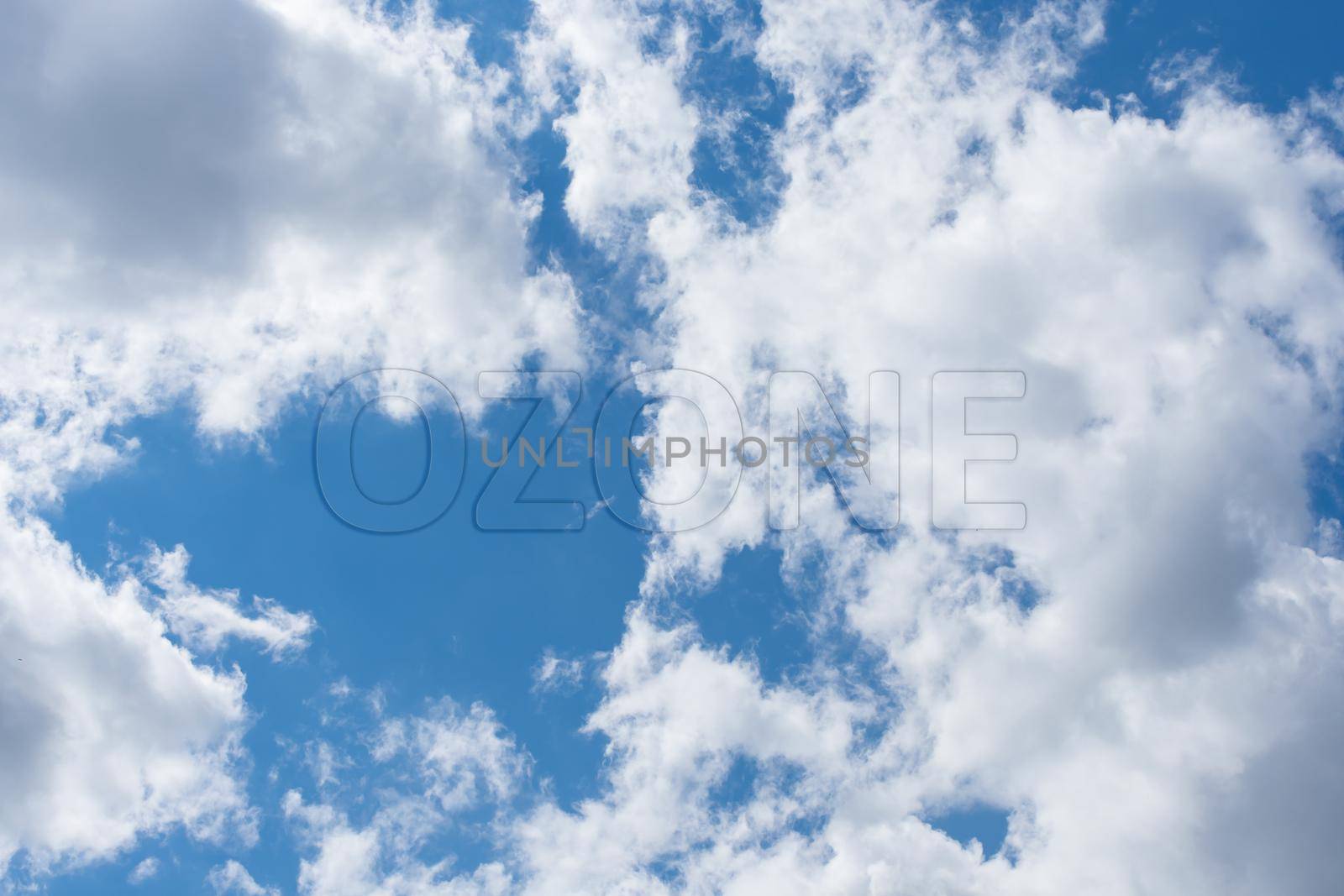 Clear clouds soaring in the sky and the inscription ozone symbolizing freedom and air