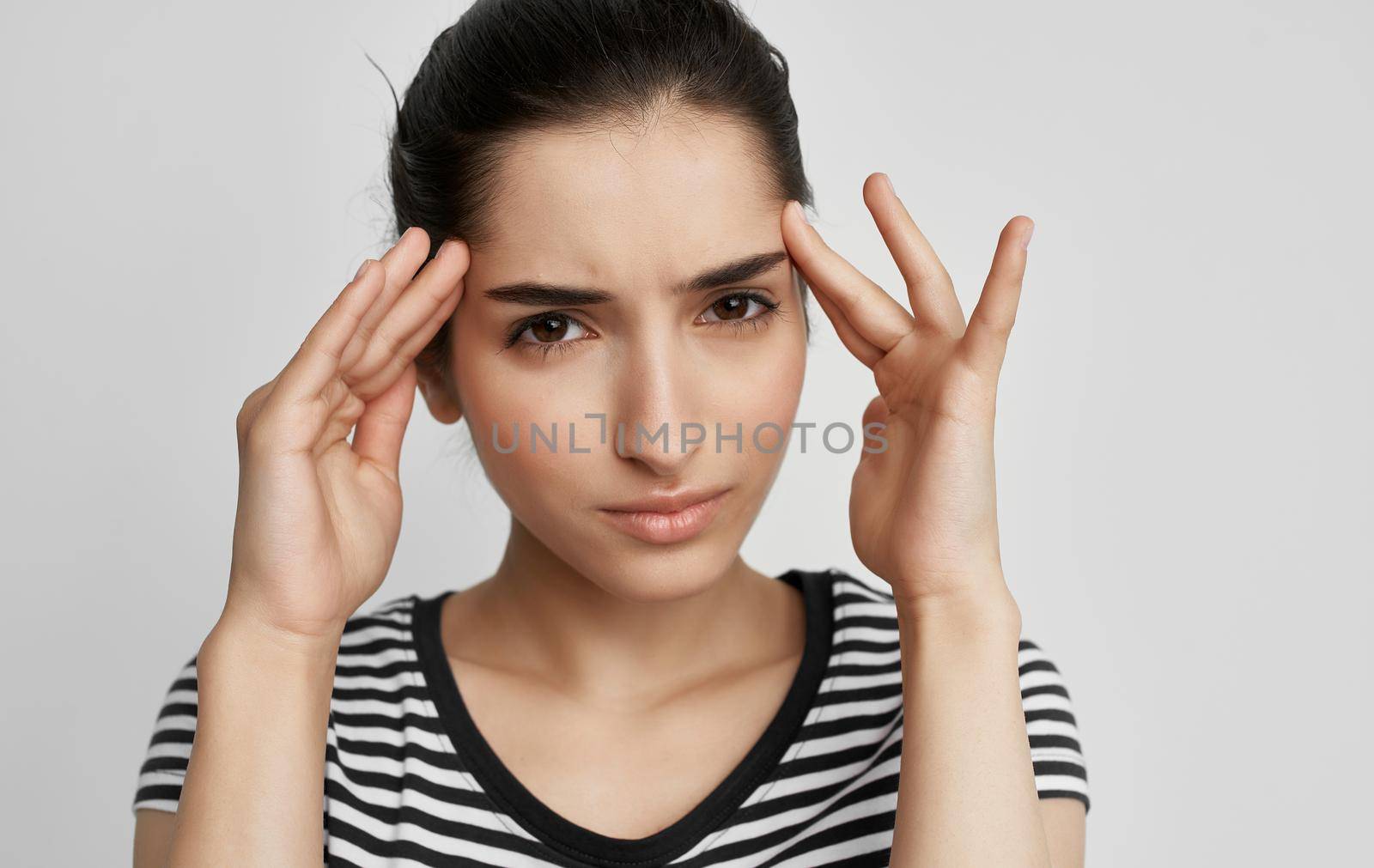 woman in t-shirt holding her head discontent health problem. High quality photo