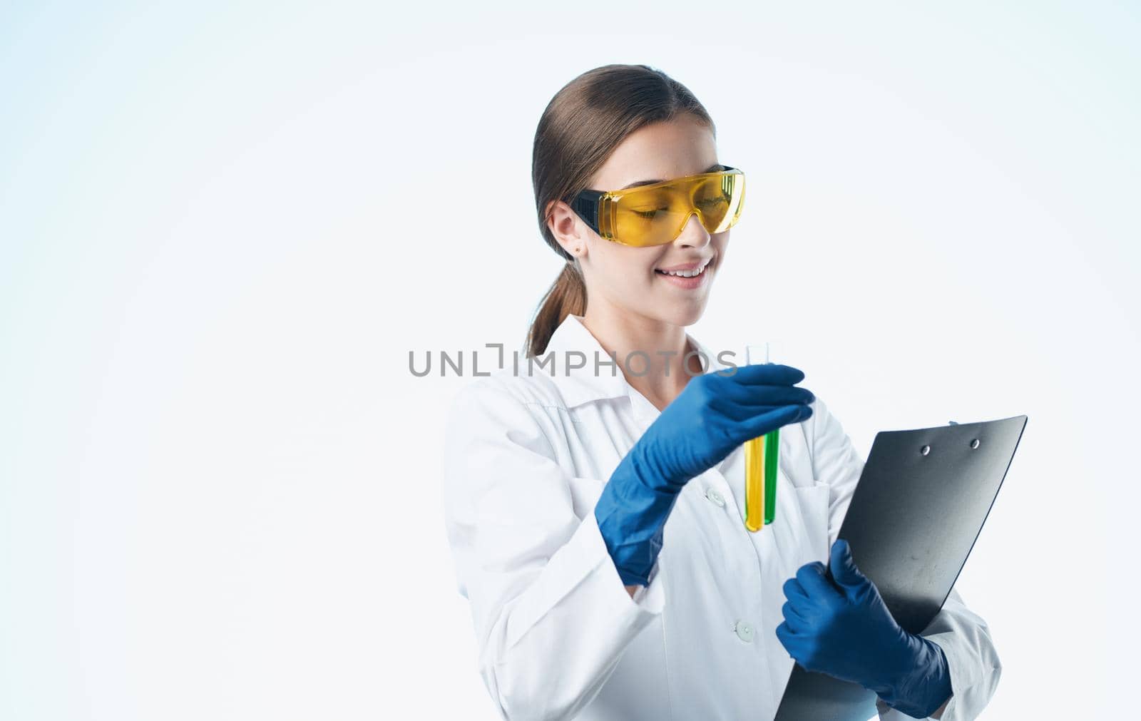 woman doctor in medical gloves and in a white medical coat holds flasks in her hands documents. High quality photo