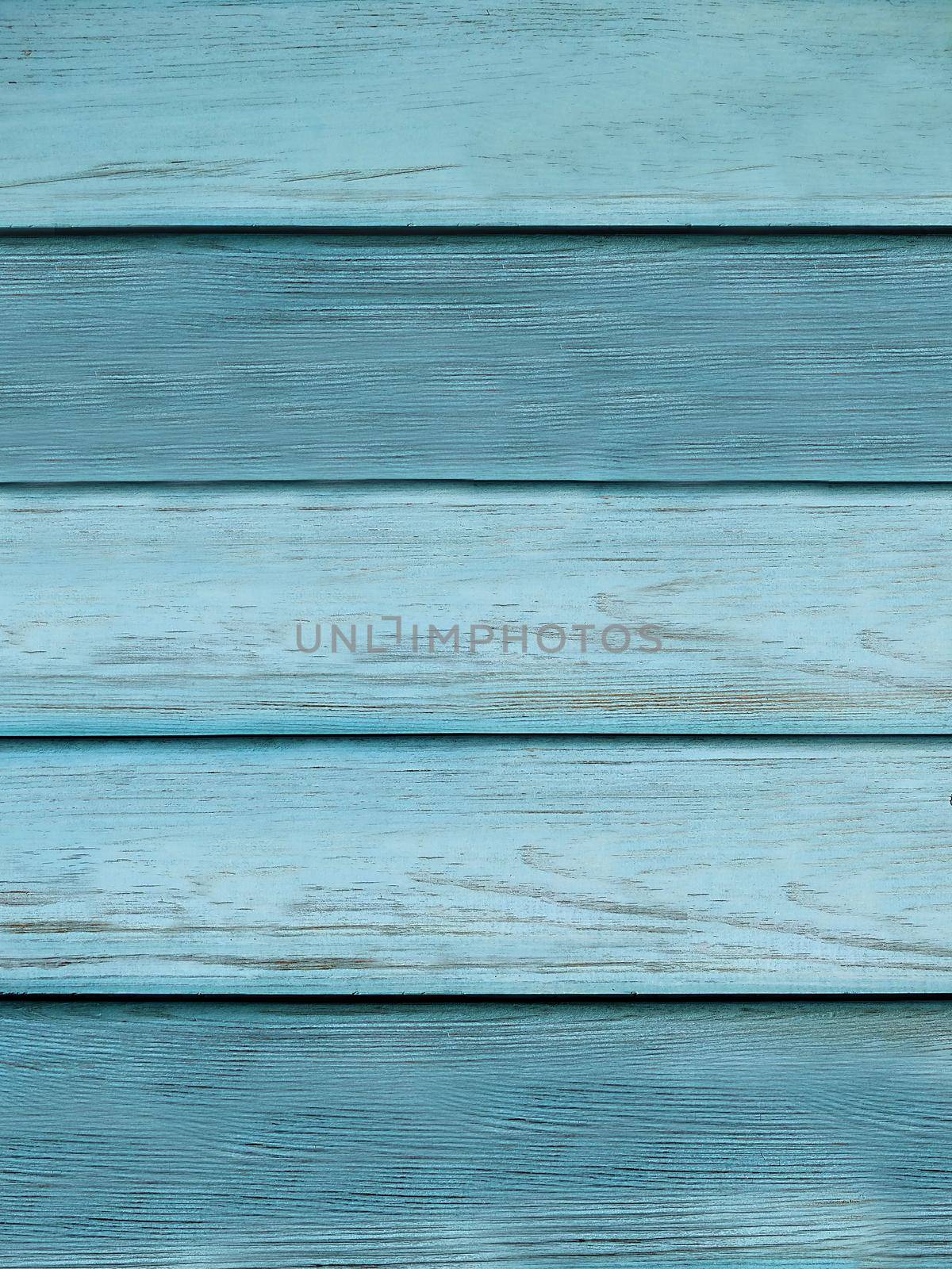 The wall is made of planks with a textured surface of light blue color.Texture or background
