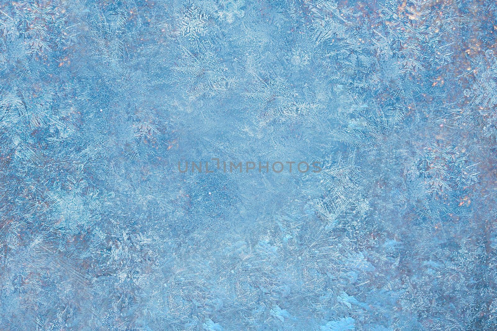 Blue background pattern made by frost on the window.Texture or background
