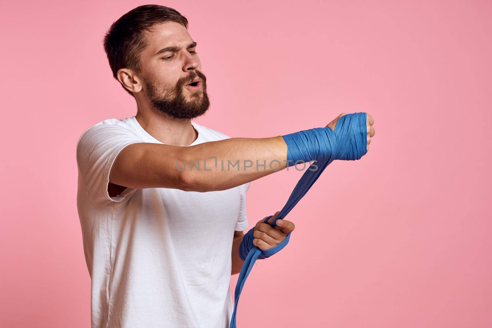 sports man boxing bandage pink workout background. High quality photo