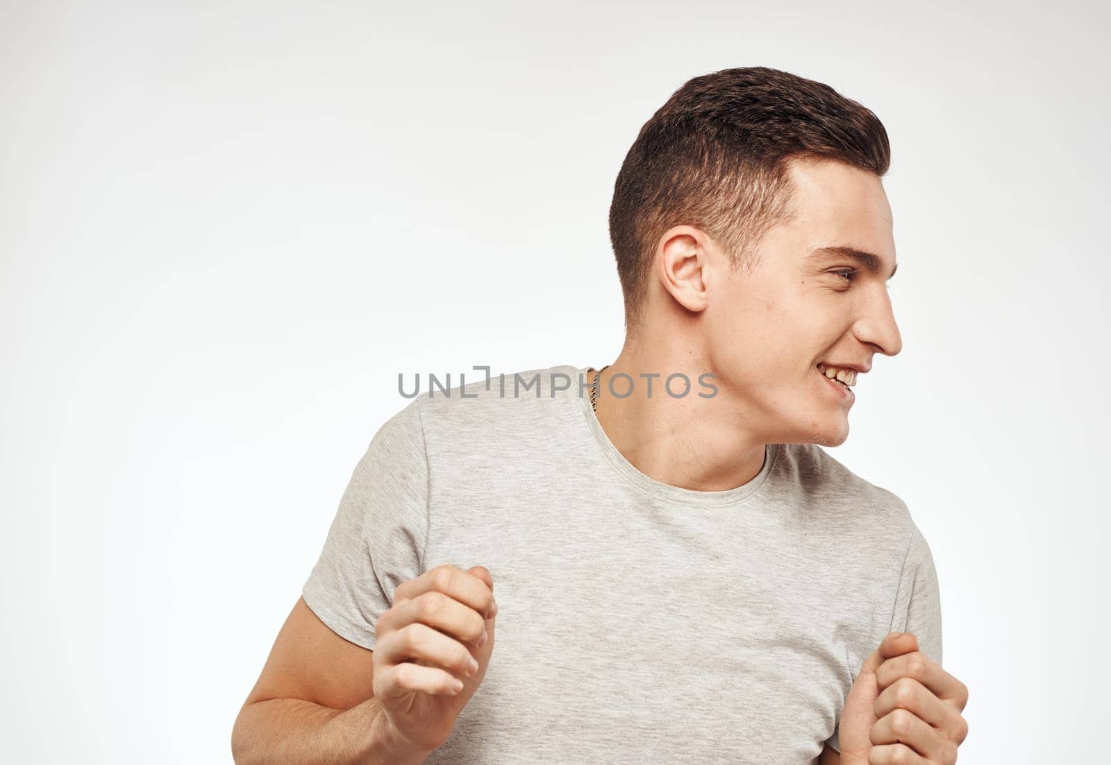 Cute man in t-shirt emotions Studio fun cropped view. High quality photo