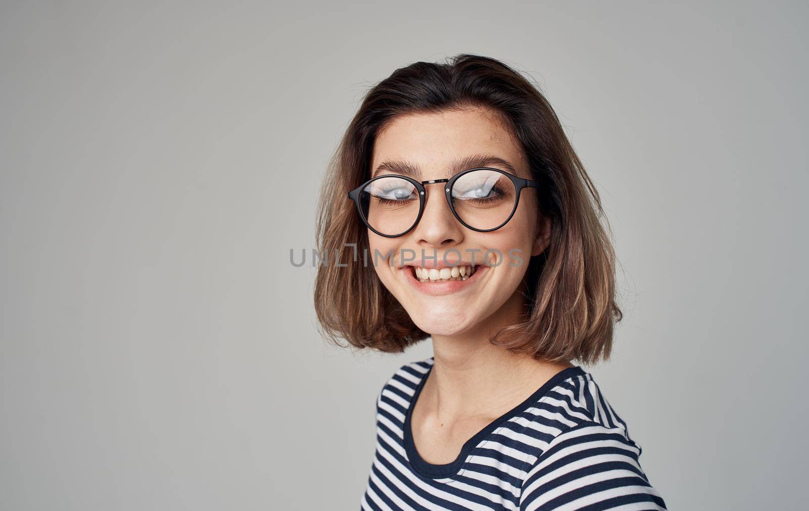 woman in striped t-shirt emotion smile glasses model. High quality photo