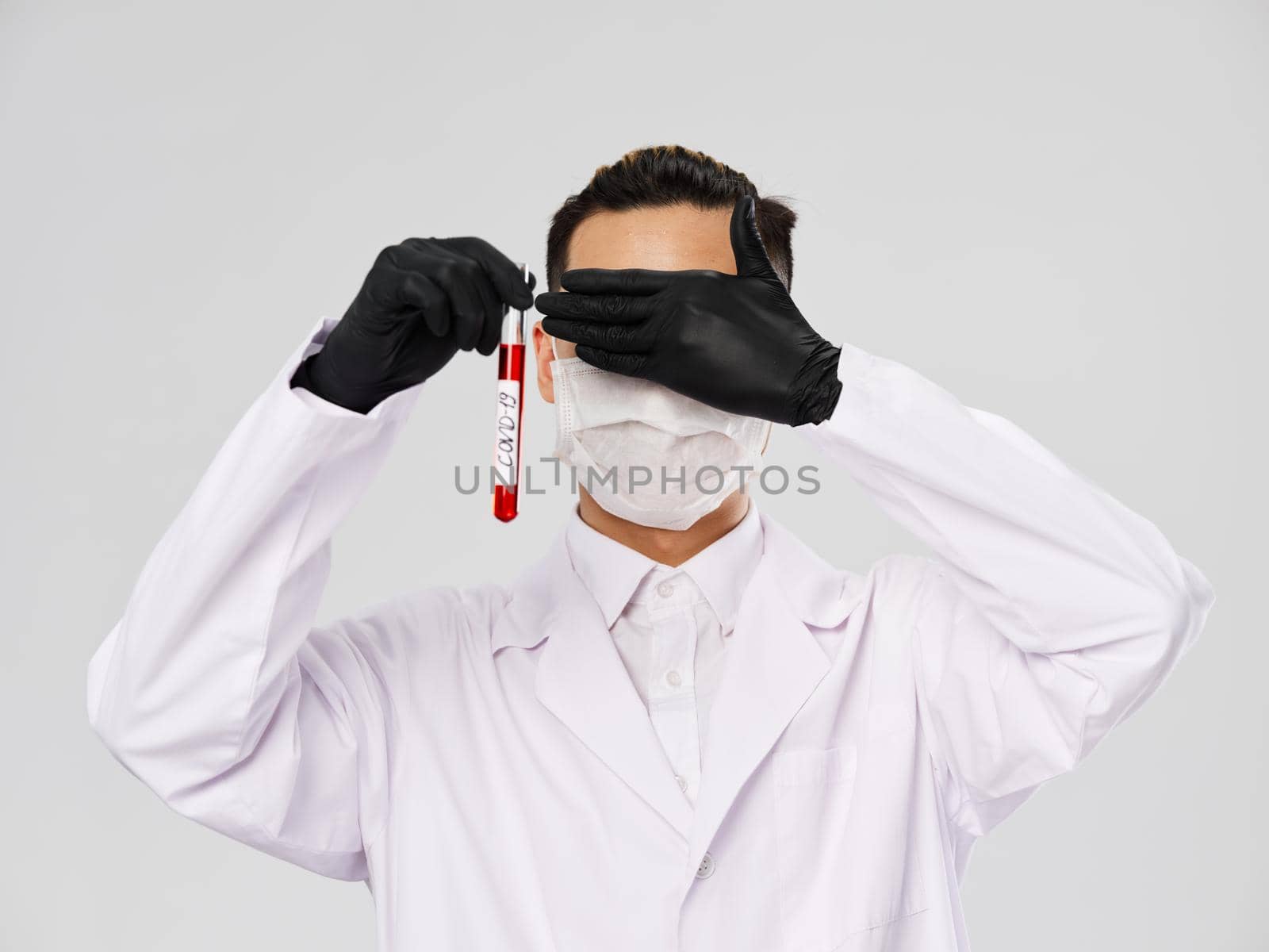 laboratory assistant closes eyes analyzes diagnostics research gray background. High quality photo