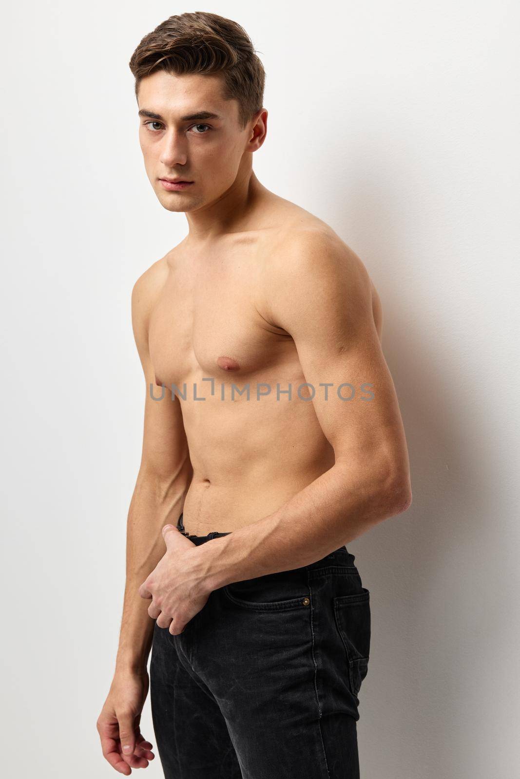 handsome man fashion hairstyle nude torso cropped view studio posing by SHOTPRIME