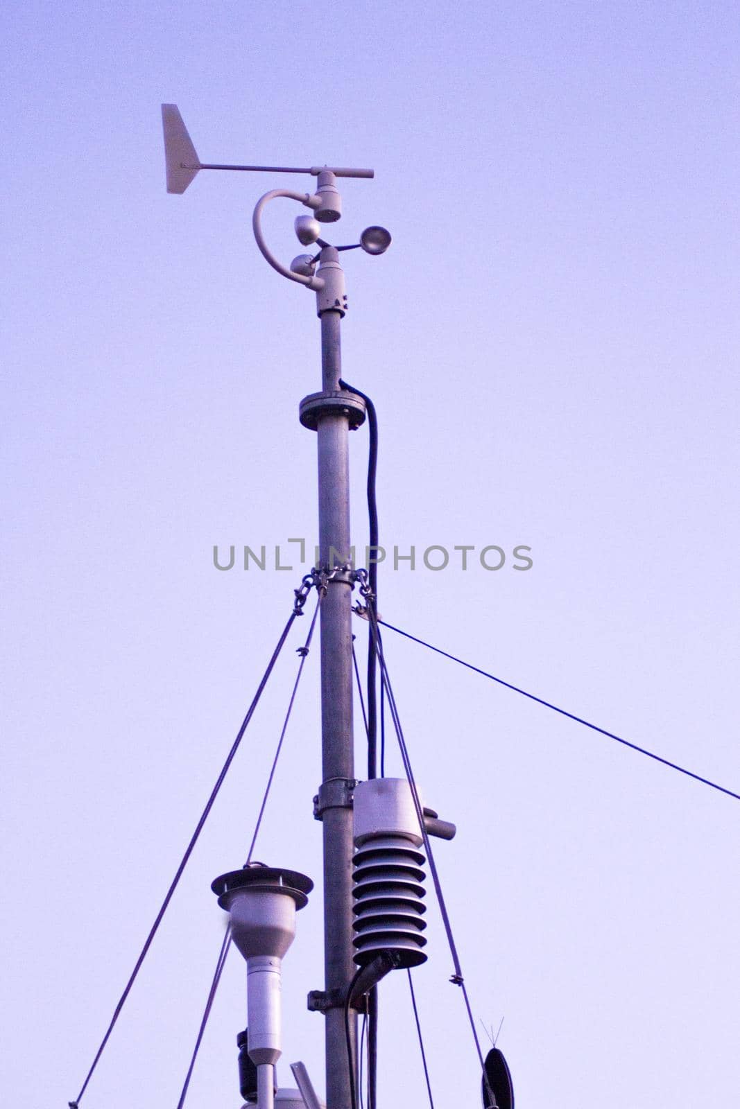 Weather station in silhouette over the sky at sunset. No people