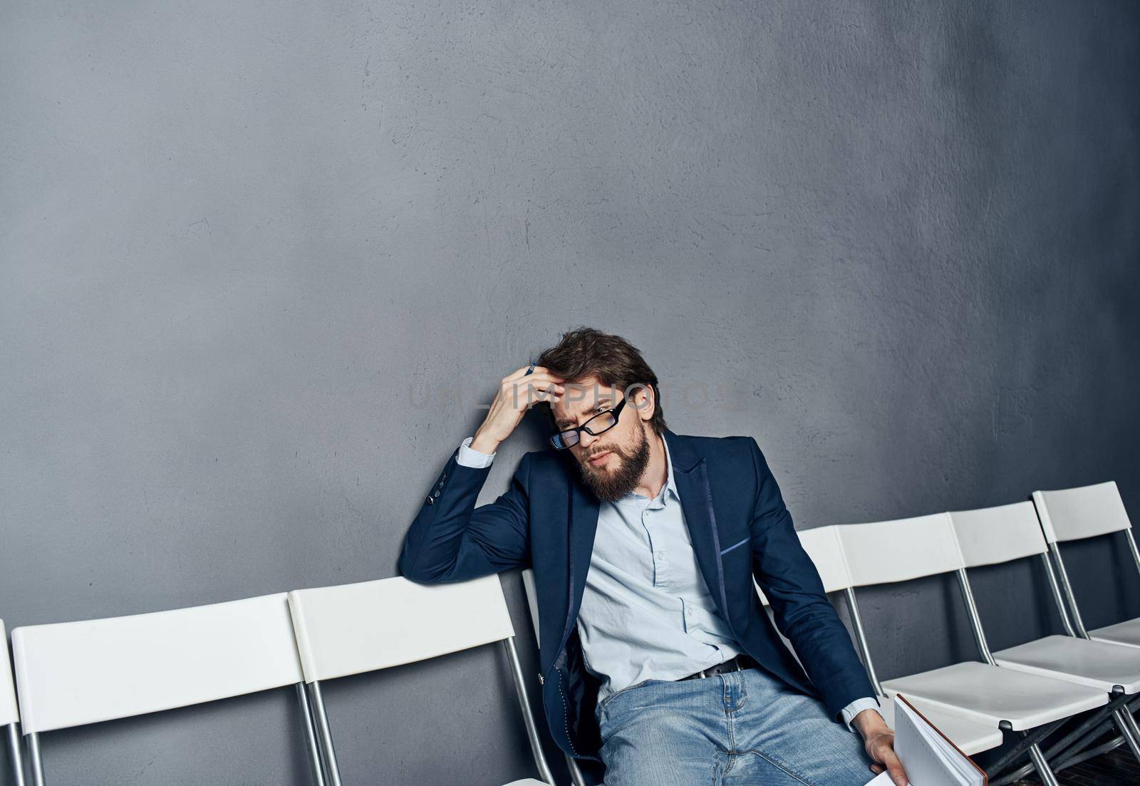 A man in a suit waiting for a job interview trying emotions. High quality photo