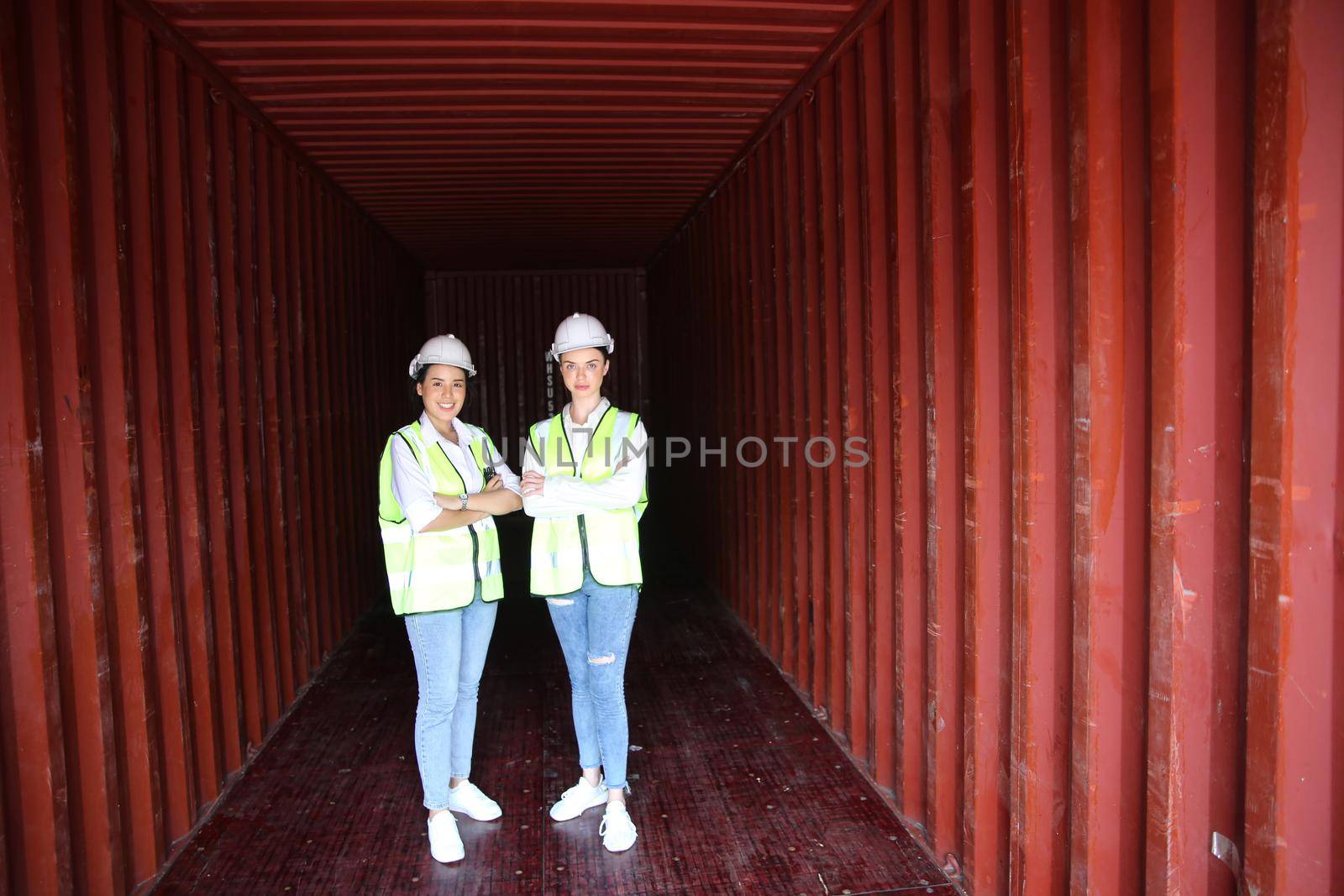 Logistics engineer control at the port, loading containers for trucks export and importing logistic concept