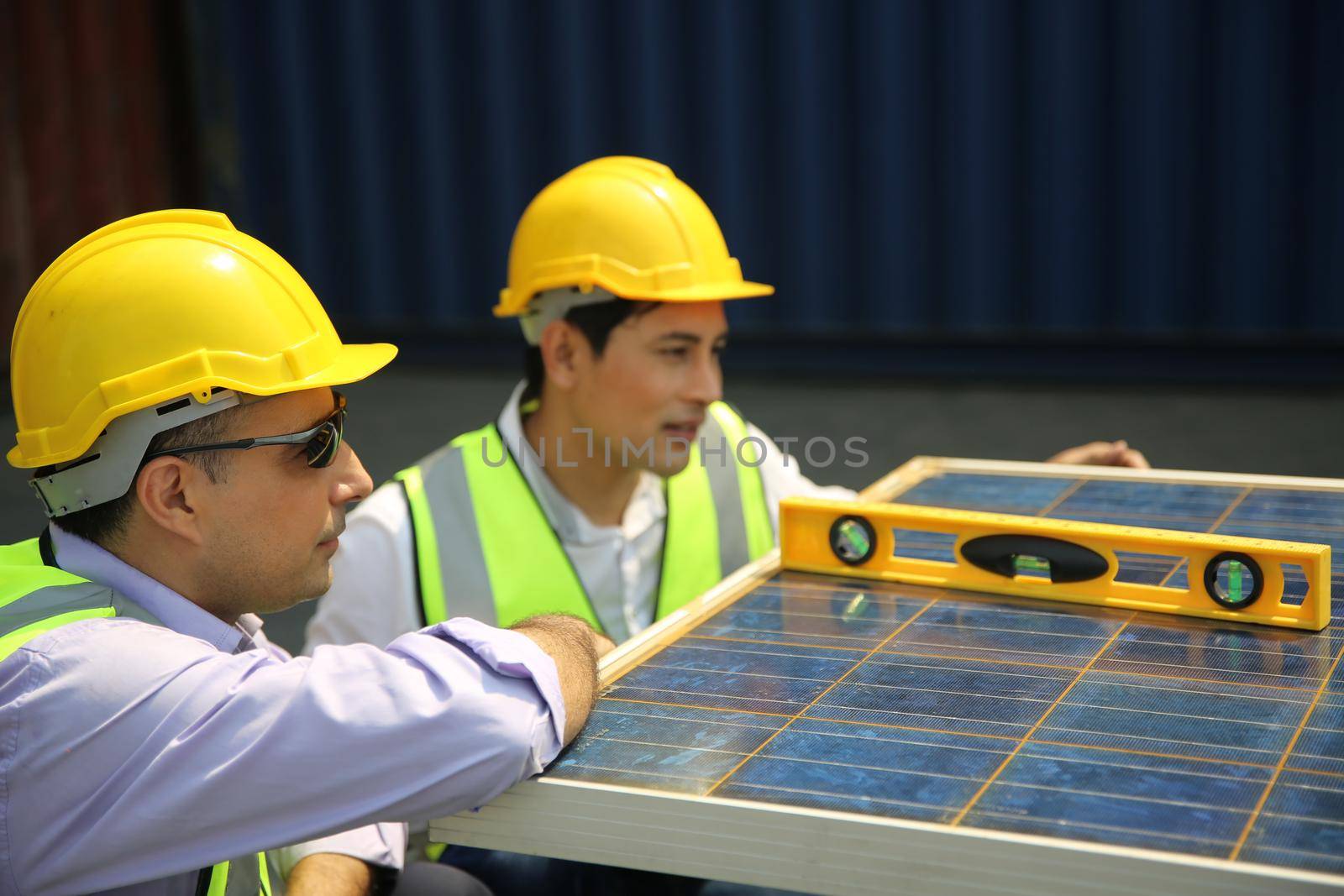 technicians install panels Solar cells to produce and distribute electricity. Energy technology concept by chuanchai