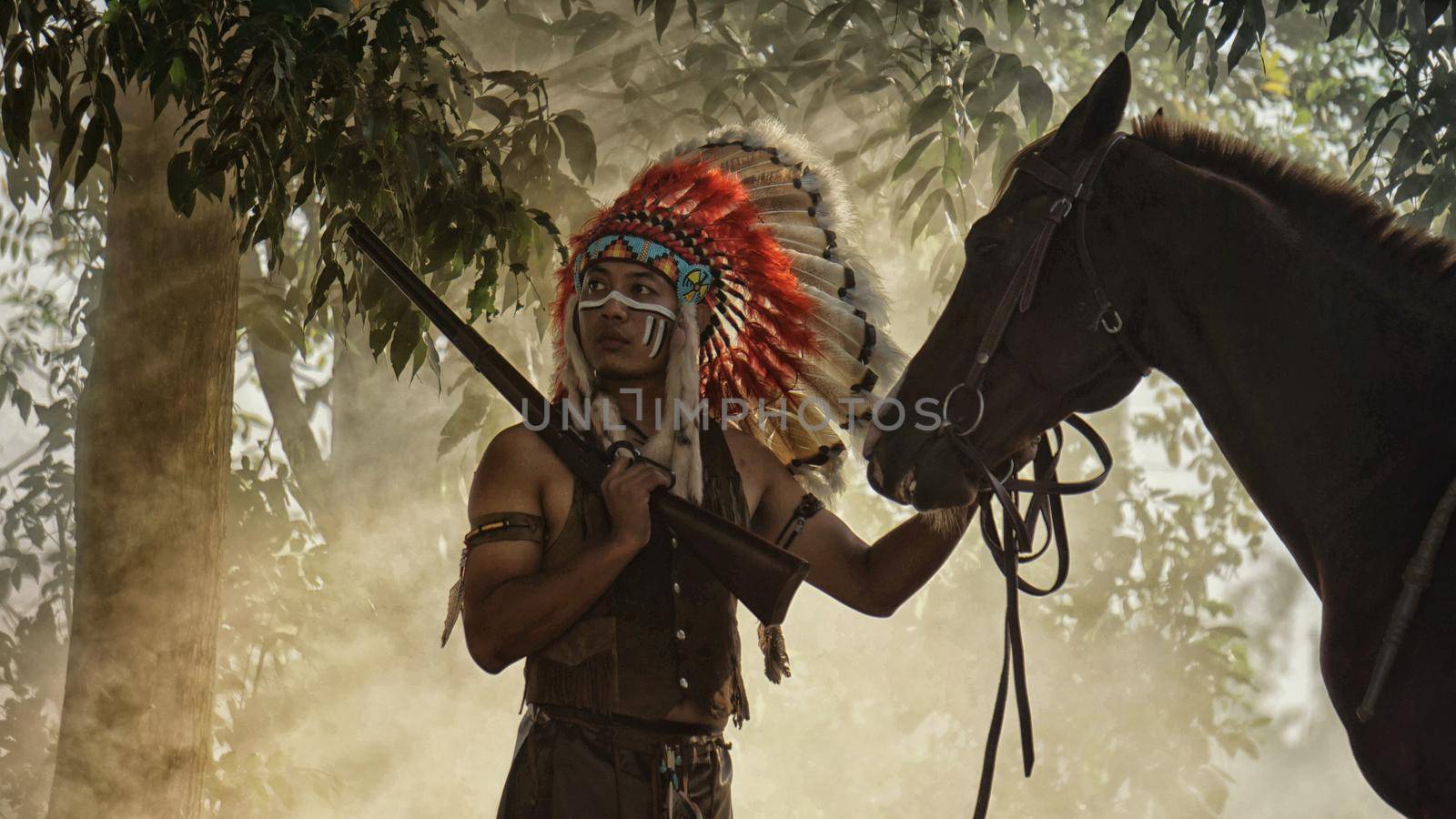 The Indians are riding a horse and spear ready to use In light of the Silhouette, American Indian warrior, chief of the tribe. man with feather he