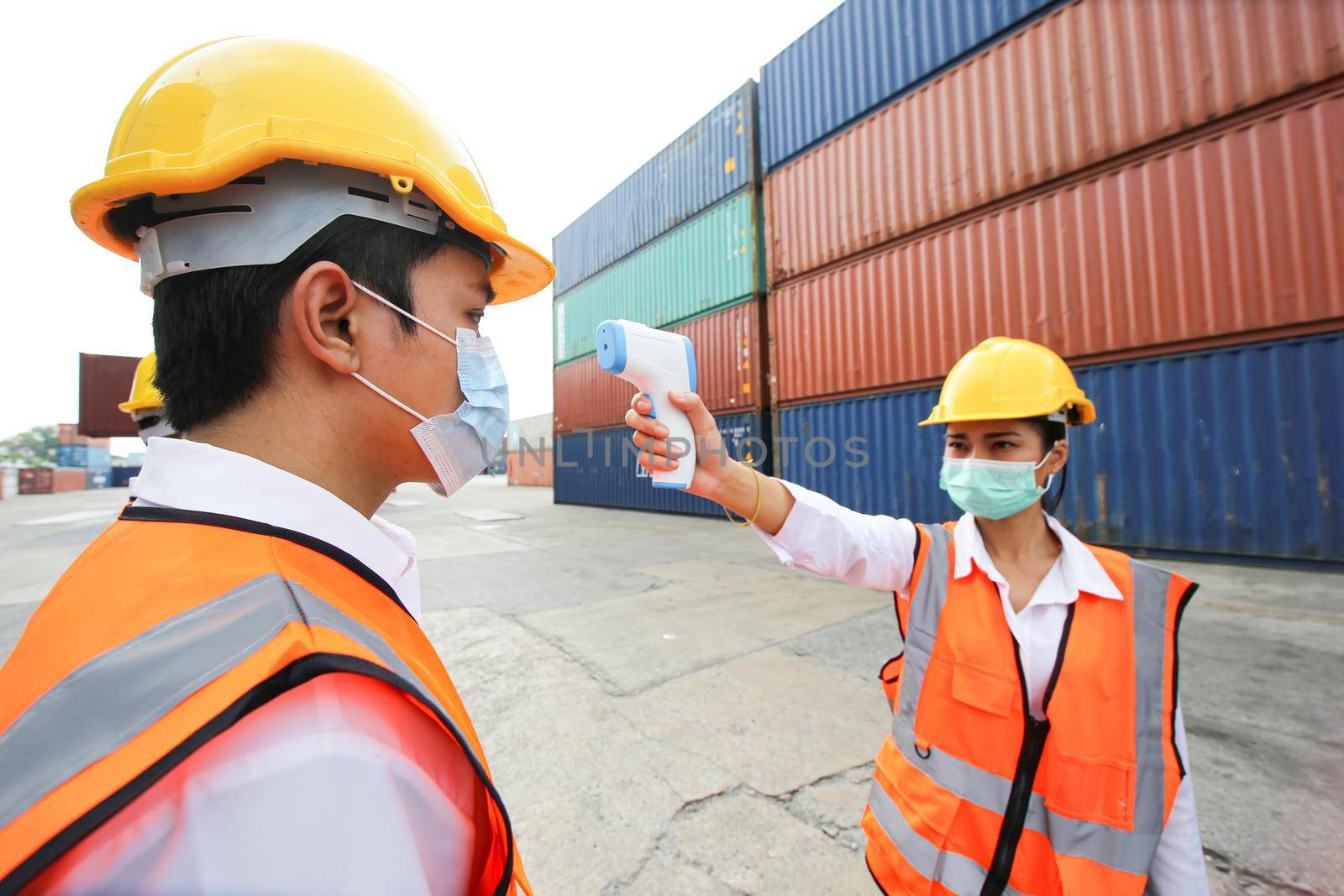 Foreman control loading Containers box from Cargo freight ship for import export. Container Warehouse Worker