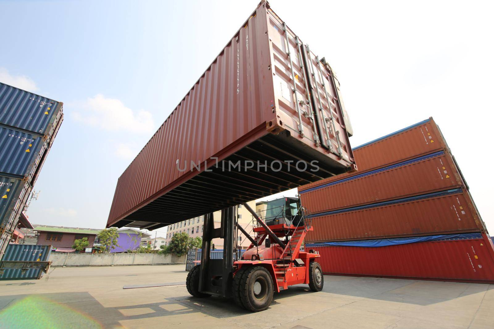 Foreman control loading Containers box from Cargo freight ship for import export. Container Warehouse Worker. by chuanchai
