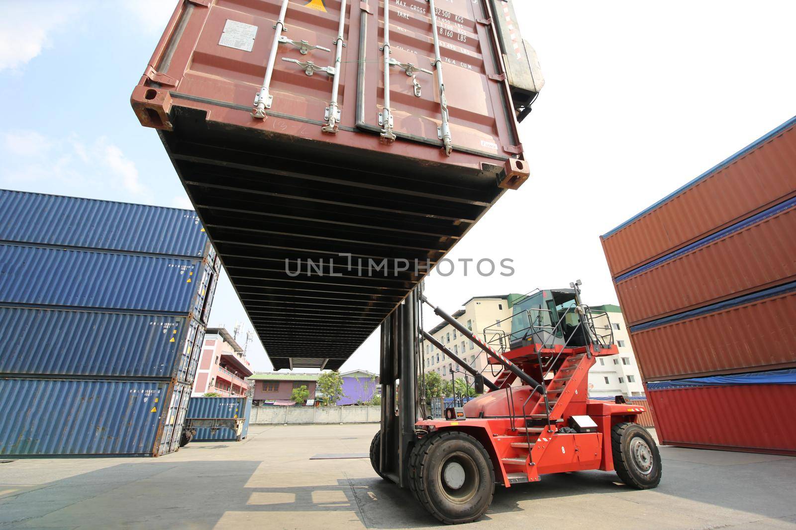 Foreman control loading Containers box from Cargo freight ship for import export. Container Warehouse Worker. by chuanchai