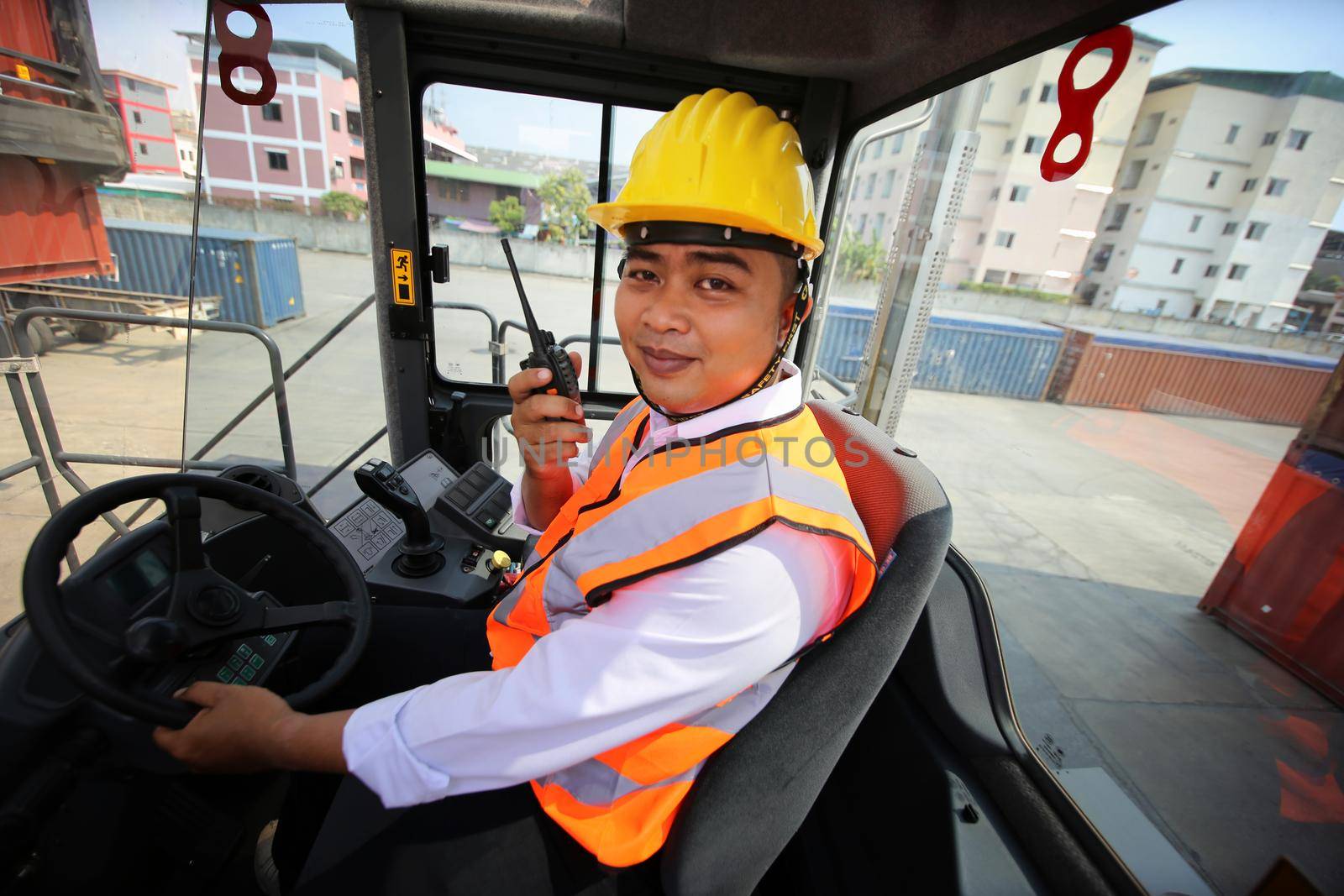 Foreman control loading Containers box from Cargo freight ship for import export. Container Warehouse Worker