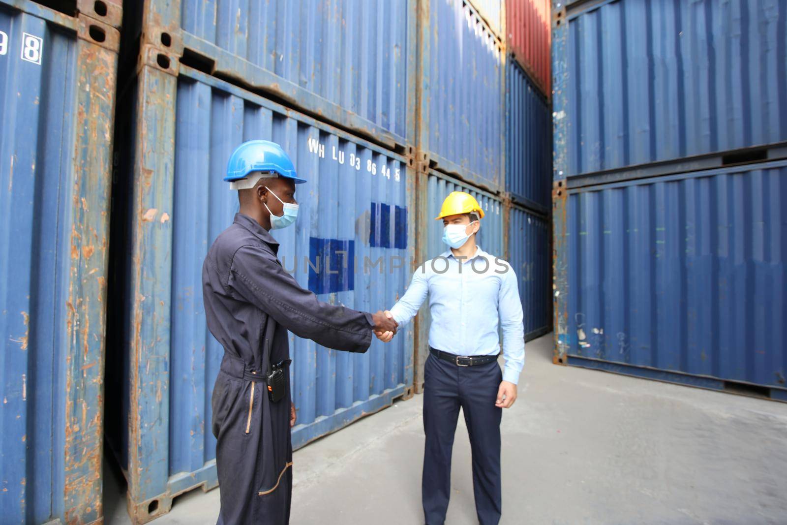 Engineer or supervisor checking and control loading Containers box from Cargo at harbor.Foreman control Industrial Container Cargo freight ship at industry.Transportation and logistic concept.  by chuanchai