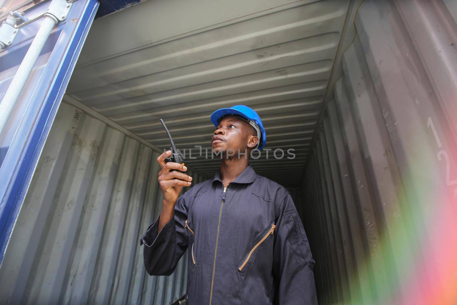 Engineer or supervisor checking and control loading Containers box from Cargo at harbor.Foreman control Industrial Container Cargo freight ship at industry.Transportation and logistic concept. 