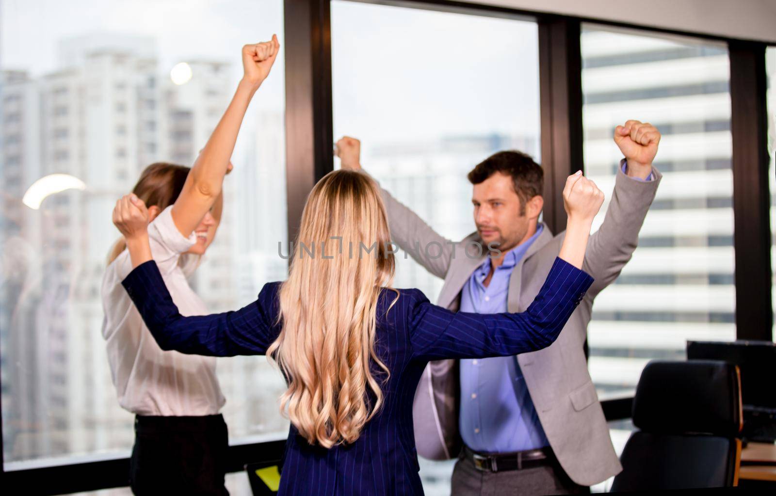 cheerful of Business coworkers hands up and working together at office by chuanchai