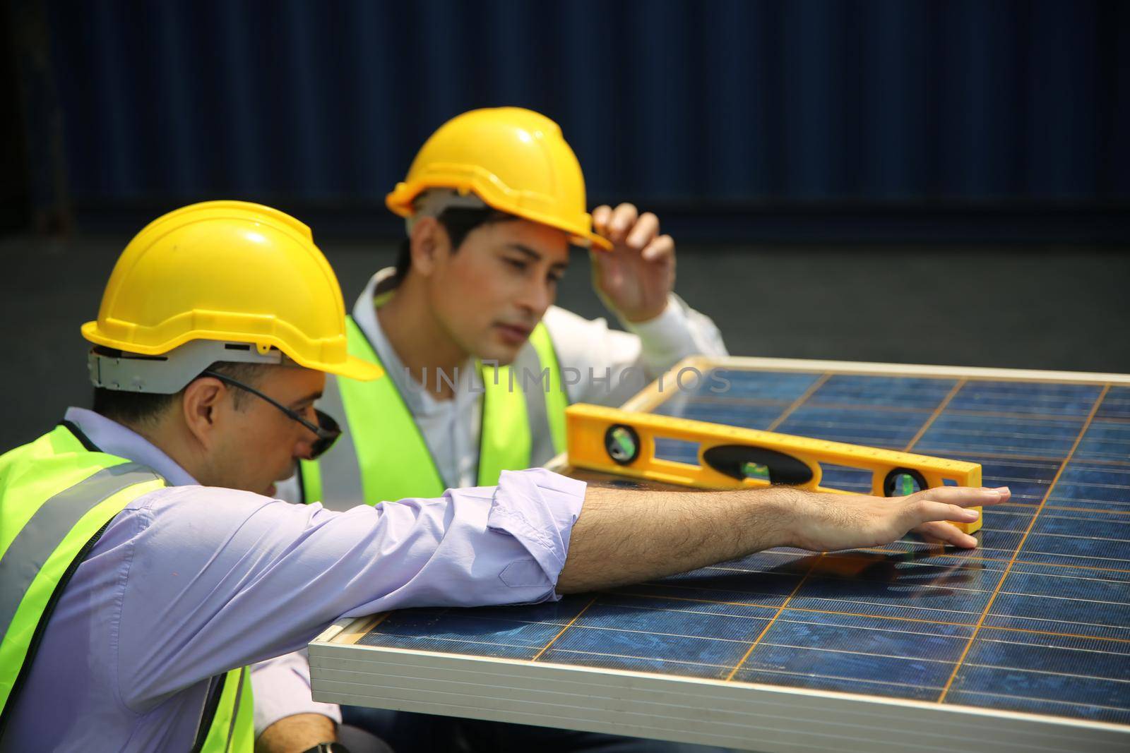 Male worker is installingsolar panel, technician installing solar panels on roof. Alternative energy sun energy power, ecological concept. 