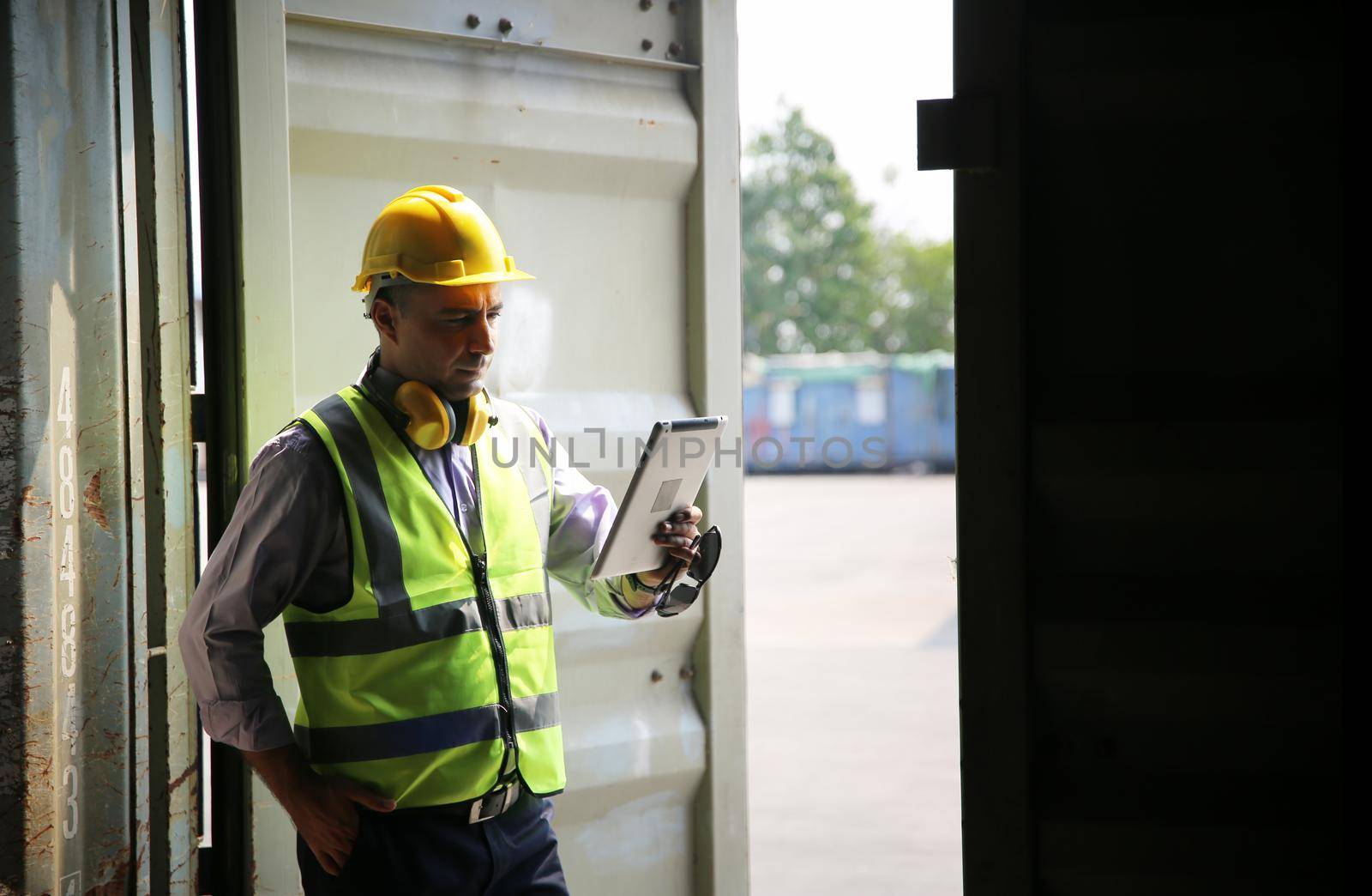 Foreman control loading Containers box from Cargo freight ship for import export.