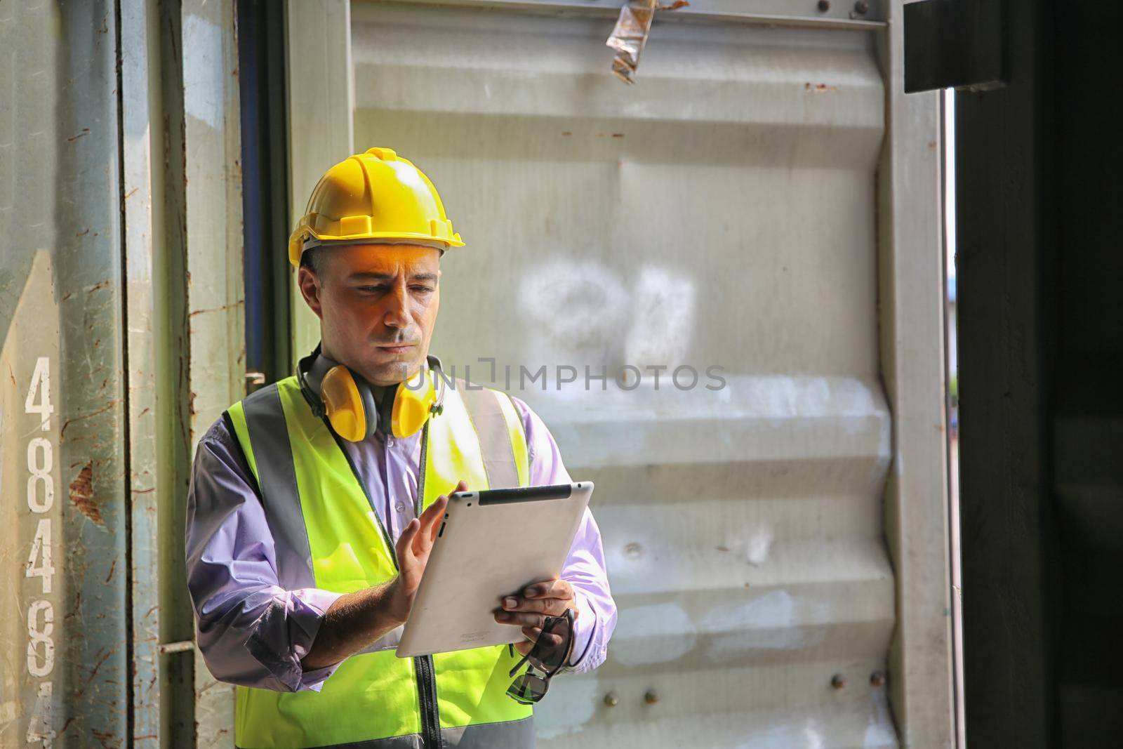 Foreman control loading Containers box from Cargo freight ship for import export.