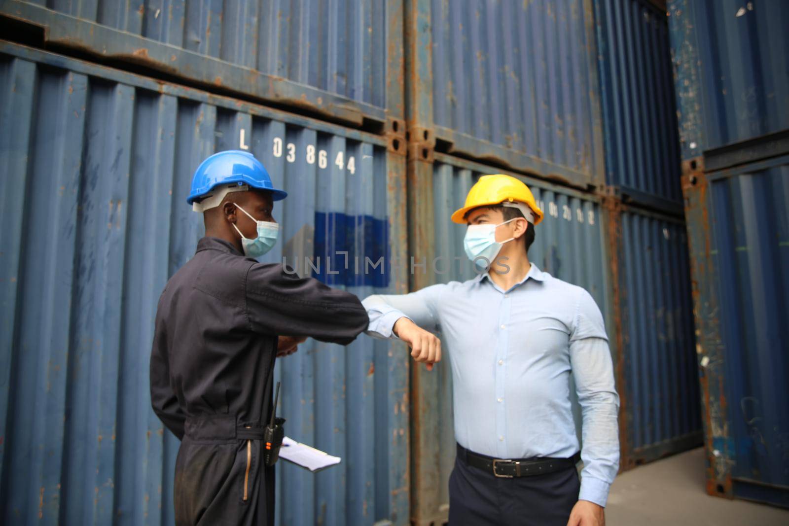 Factory industry worker working with face mask to prevent Covid-19 Coronavirus spreading during job reopening period .