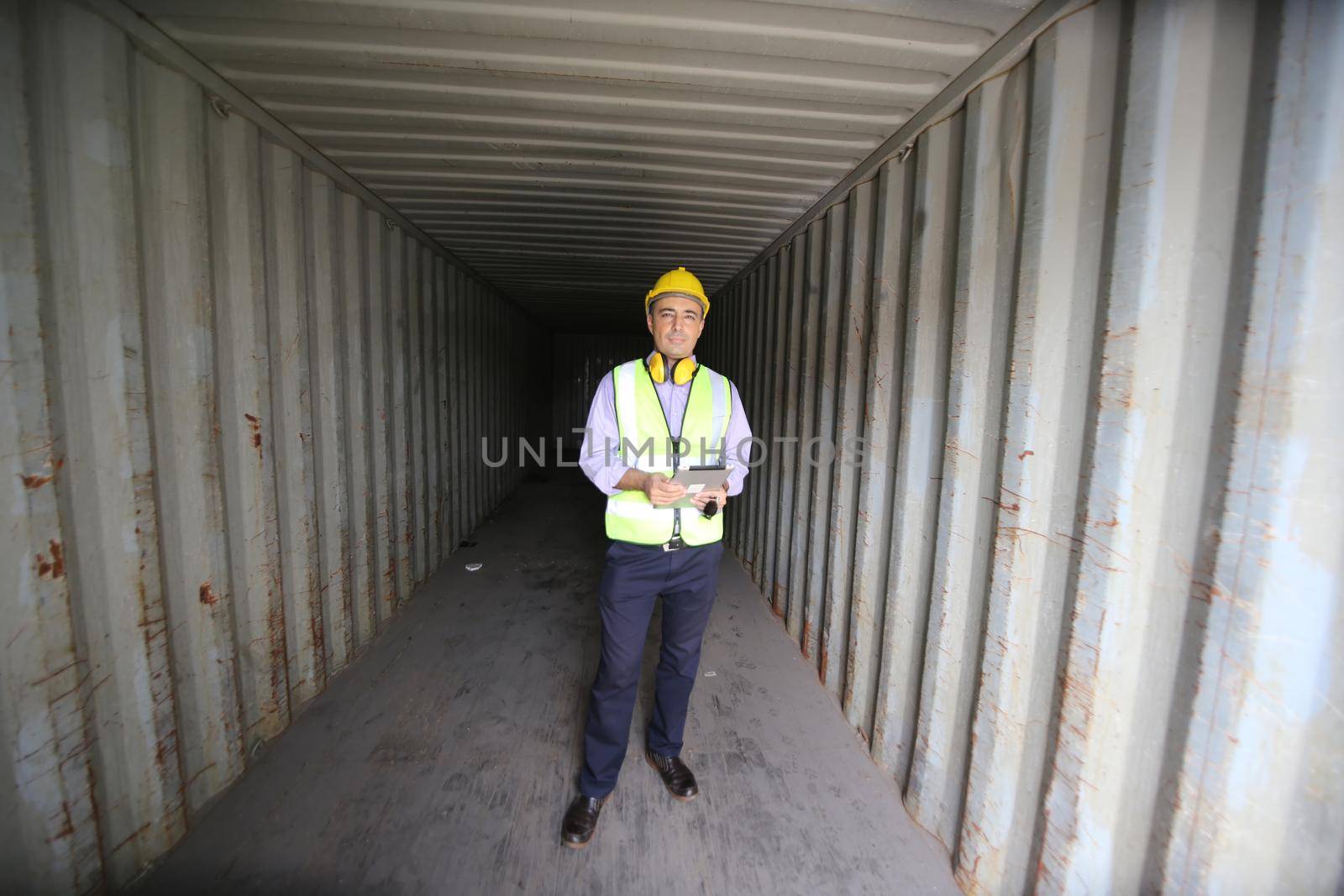 Foreman control loading Containers box from Cargo freight ship for import export.