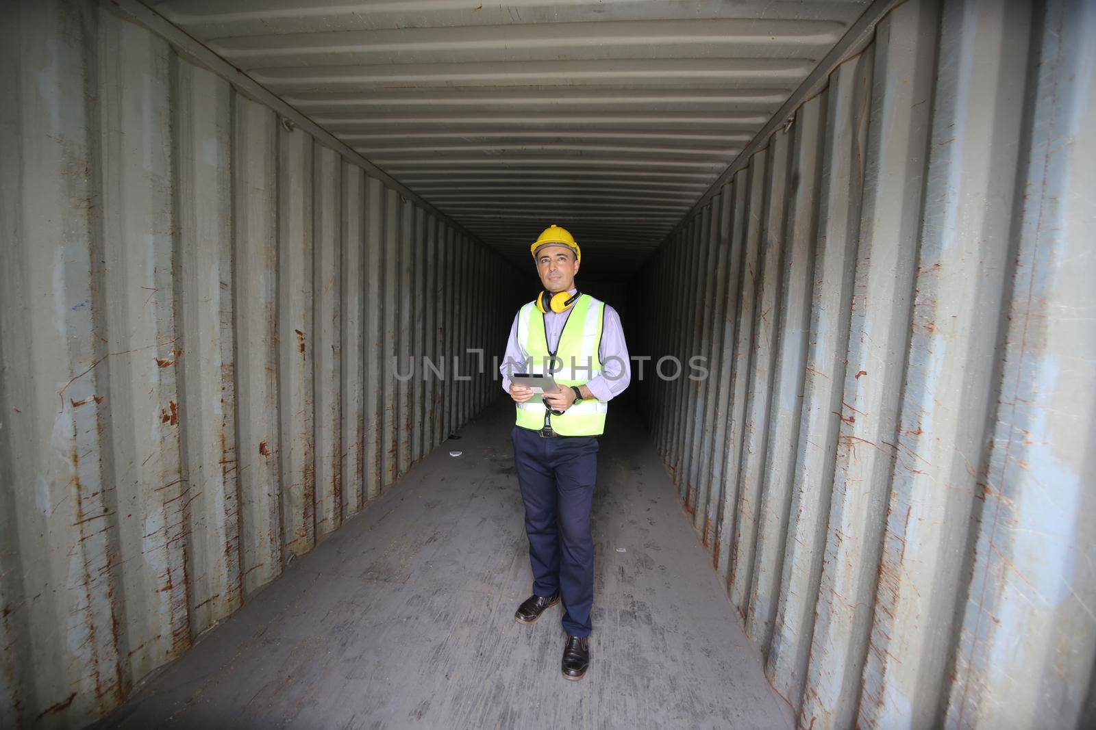 Foreman control loading Containers box from Cargo freight ship for import export.