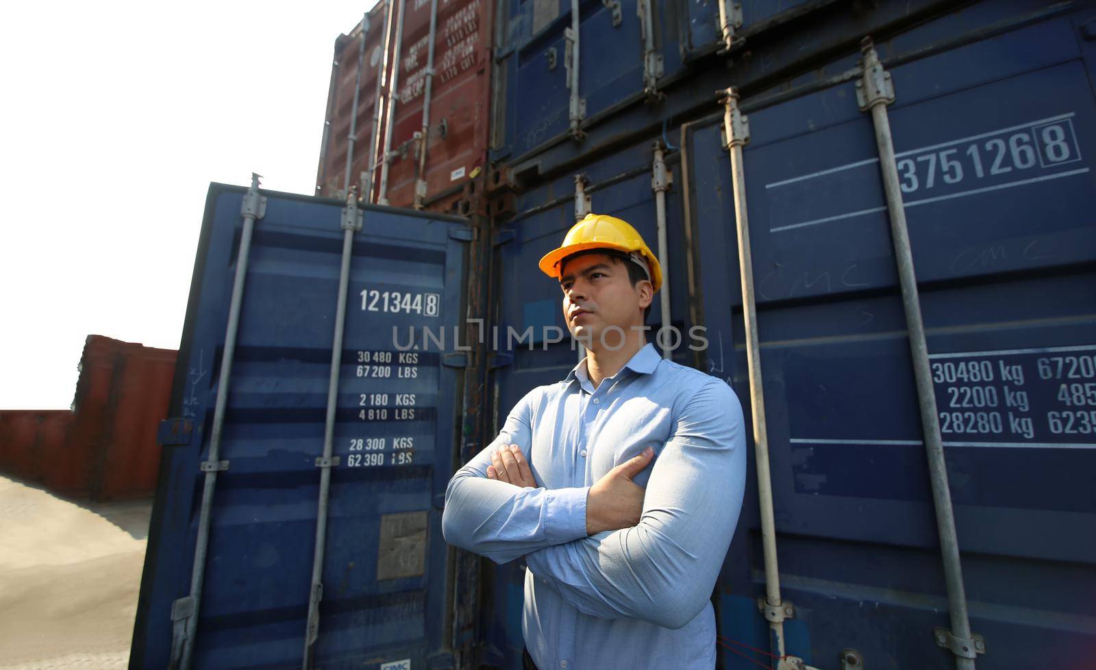 Foreman control loading Containers box from Cargo freight ship for import export.