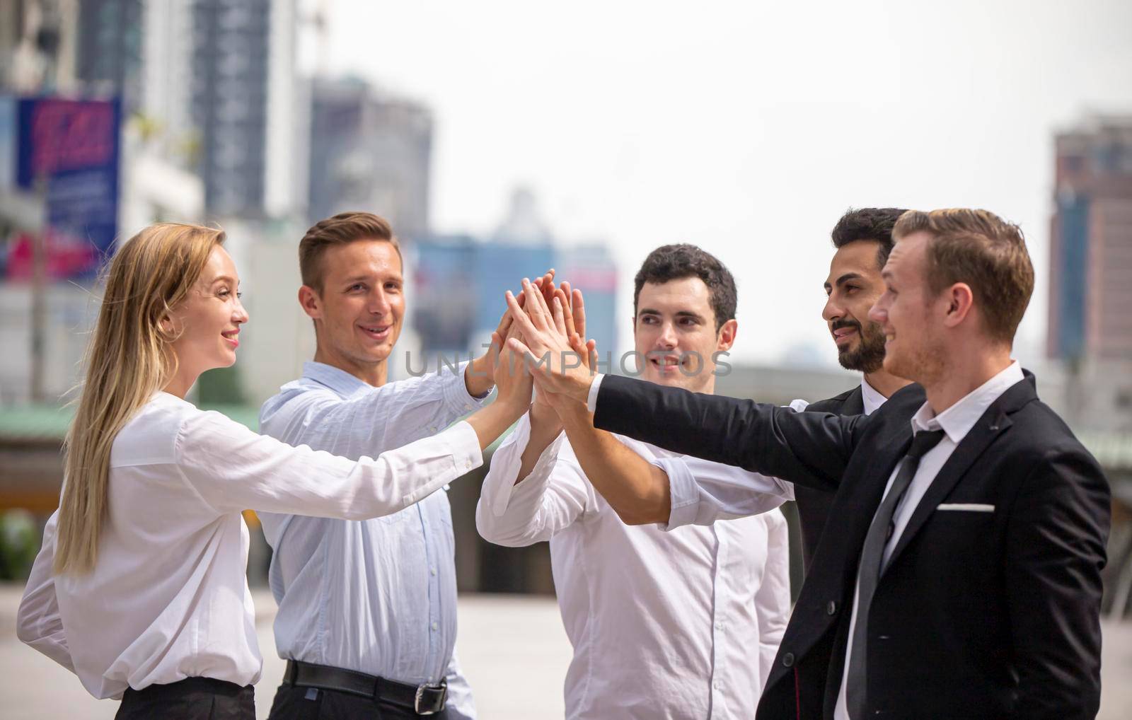 Business partners or group of diverse students put fists in circle fist bump as symbol of engagement in team building, support and synergy, help in cooperation, trust unity in teamwork, close up image