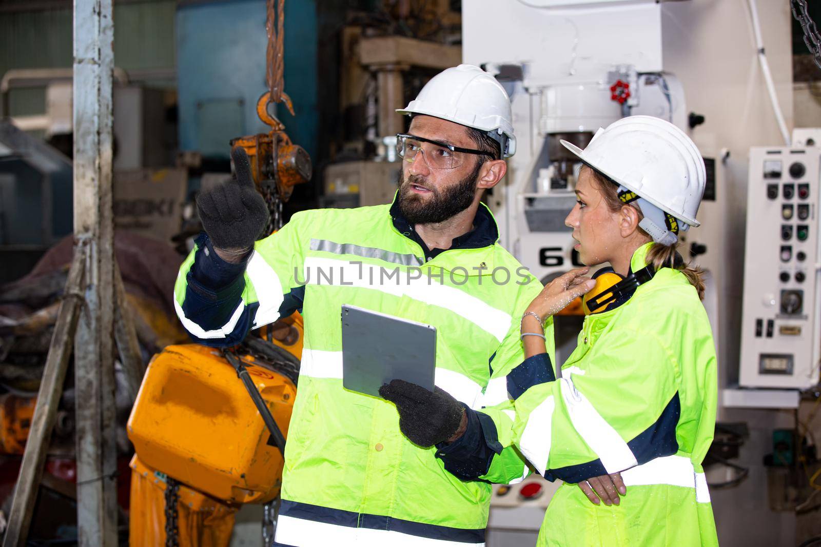 Portrait woman worker and engineer under inspection and checking production process on factory station