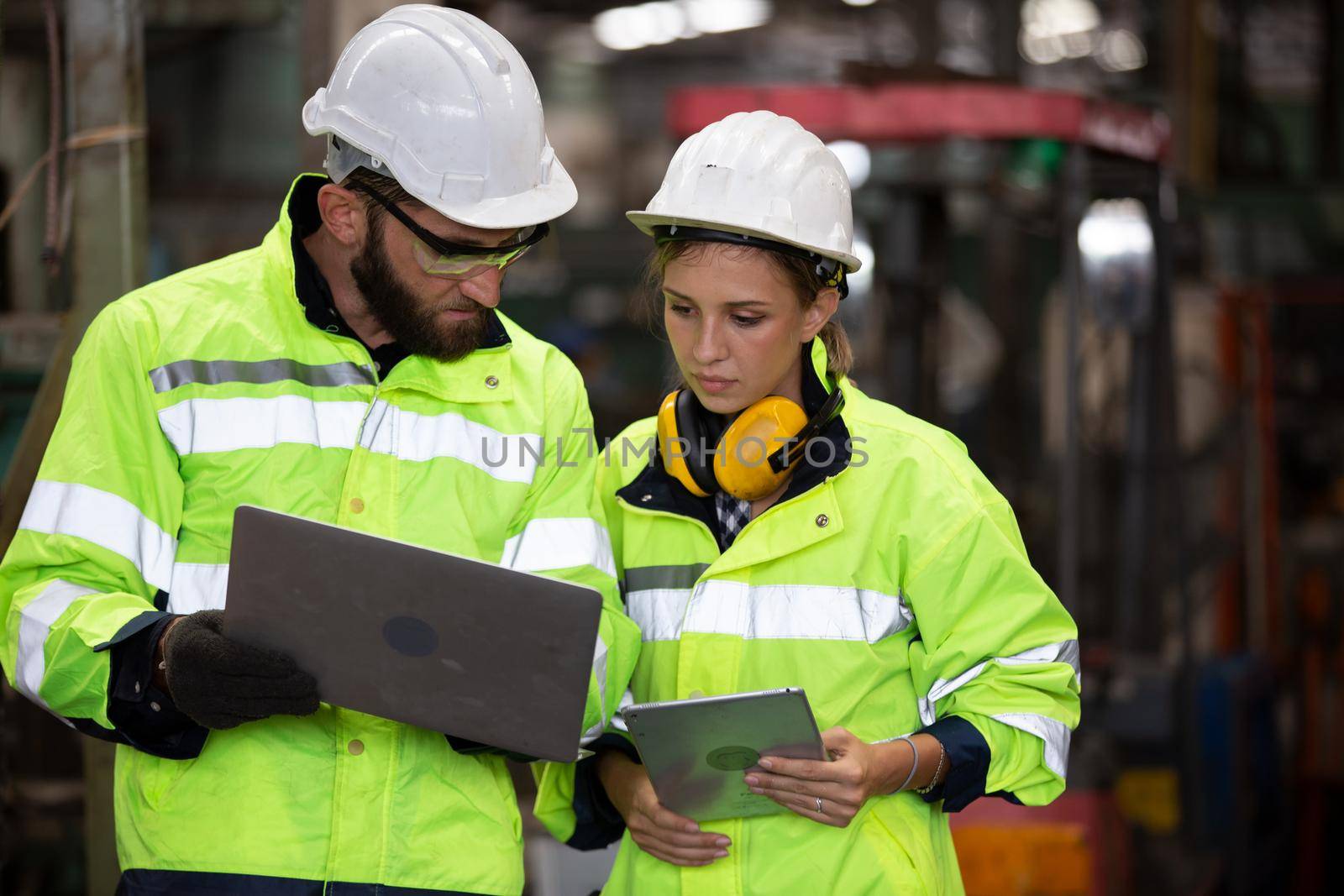 Portrait woman worker and engineer under inspection and checking production process on factory station by chuanchai