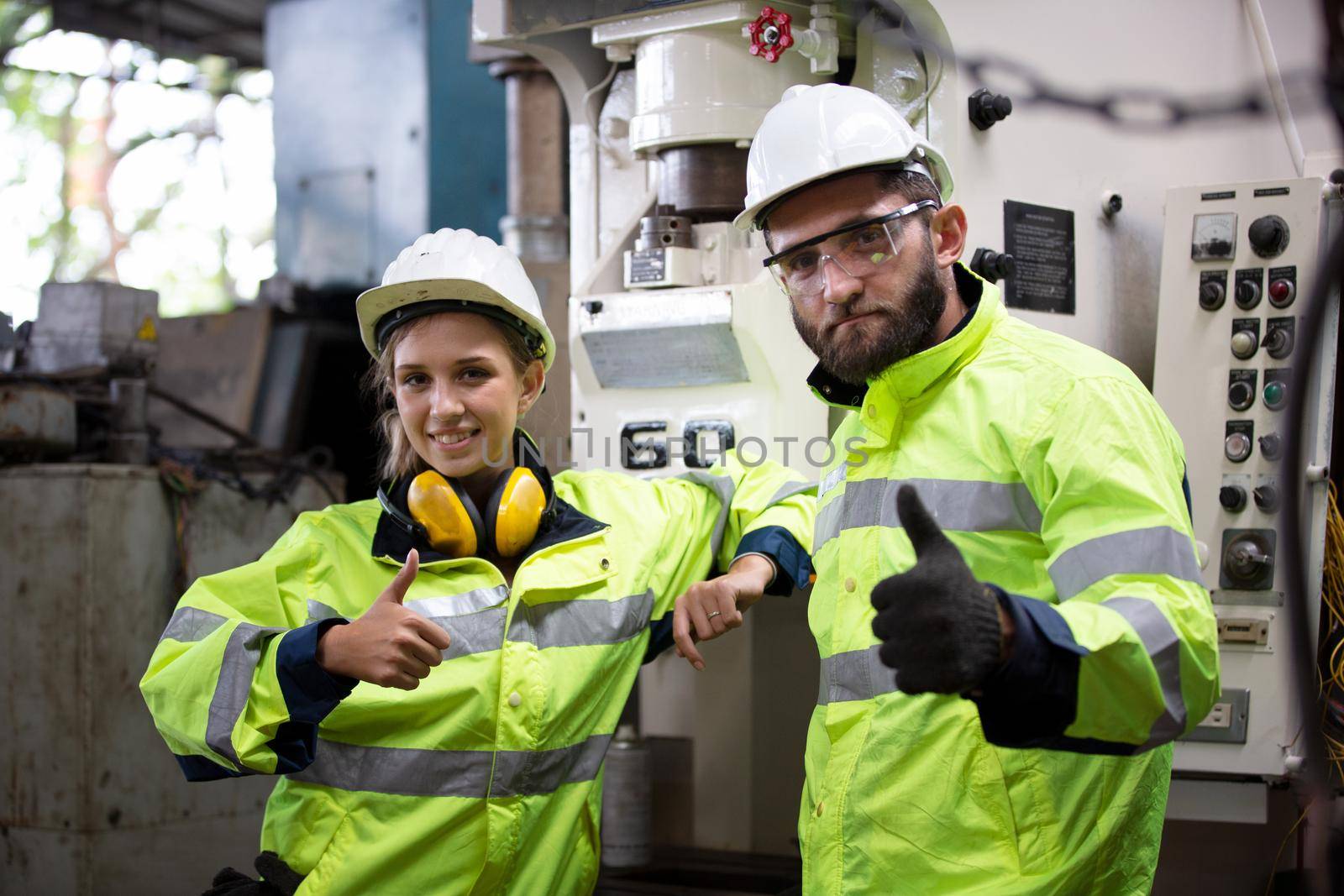 Portrait woman worker and engineer under inspection and checking production process on factory station