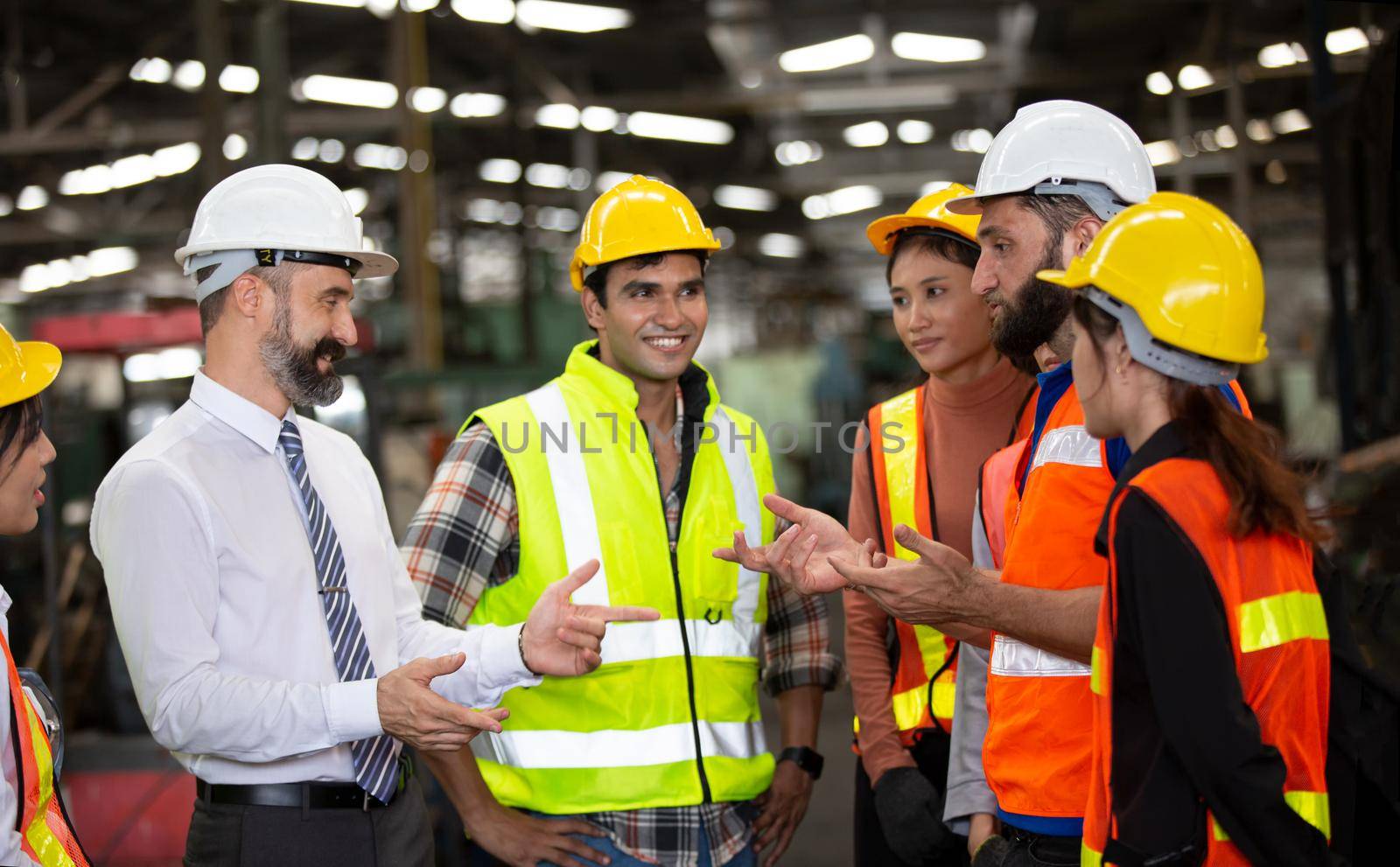 group of workers, change of workers in the factory, people go in helmets and uniforms for an industrial enterprise