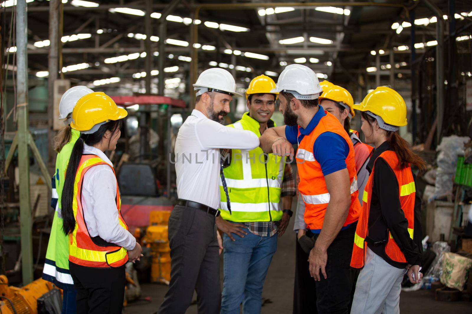 group of workers, change of workers in the factory, people go in helmets and uniforms for an industrial enterprise