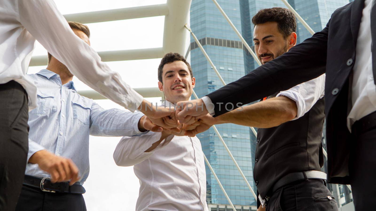 Business partners or group of diverse students put fists in circle fist bump as symbol of engagement in team building, support and synergy, help in cooperation, trust unity in teamwork, close up image