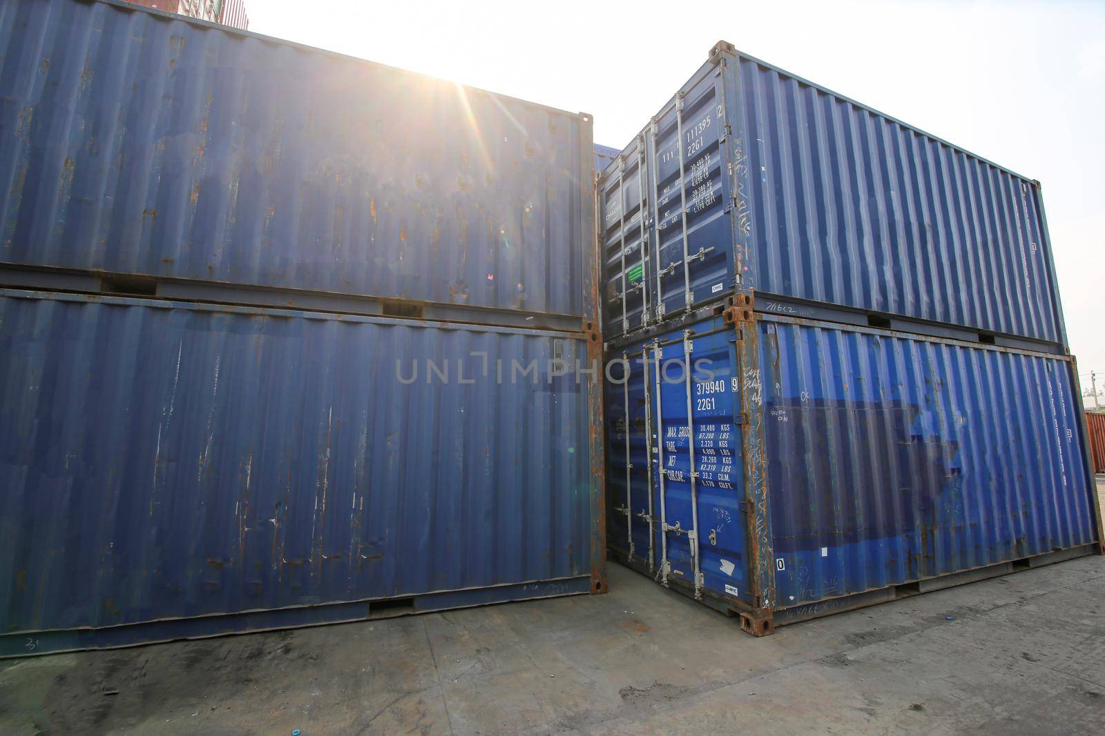  supervisor checking and control loading Containers box from Cargo at harbor. Foreman control Industrial Container Cargo freight ship at industry. Transportation and logistic concept.