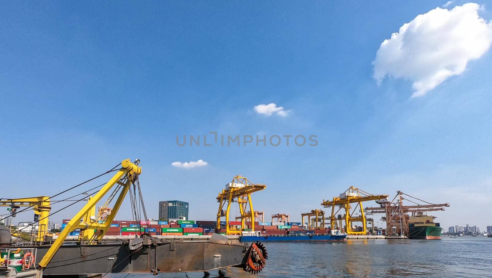  supervisor checking and control loading Containers box from Cargo at harbor. Foreman control Industrial Container Cargo freight ship at industry. Transportation and logistic concept. by chuanchai