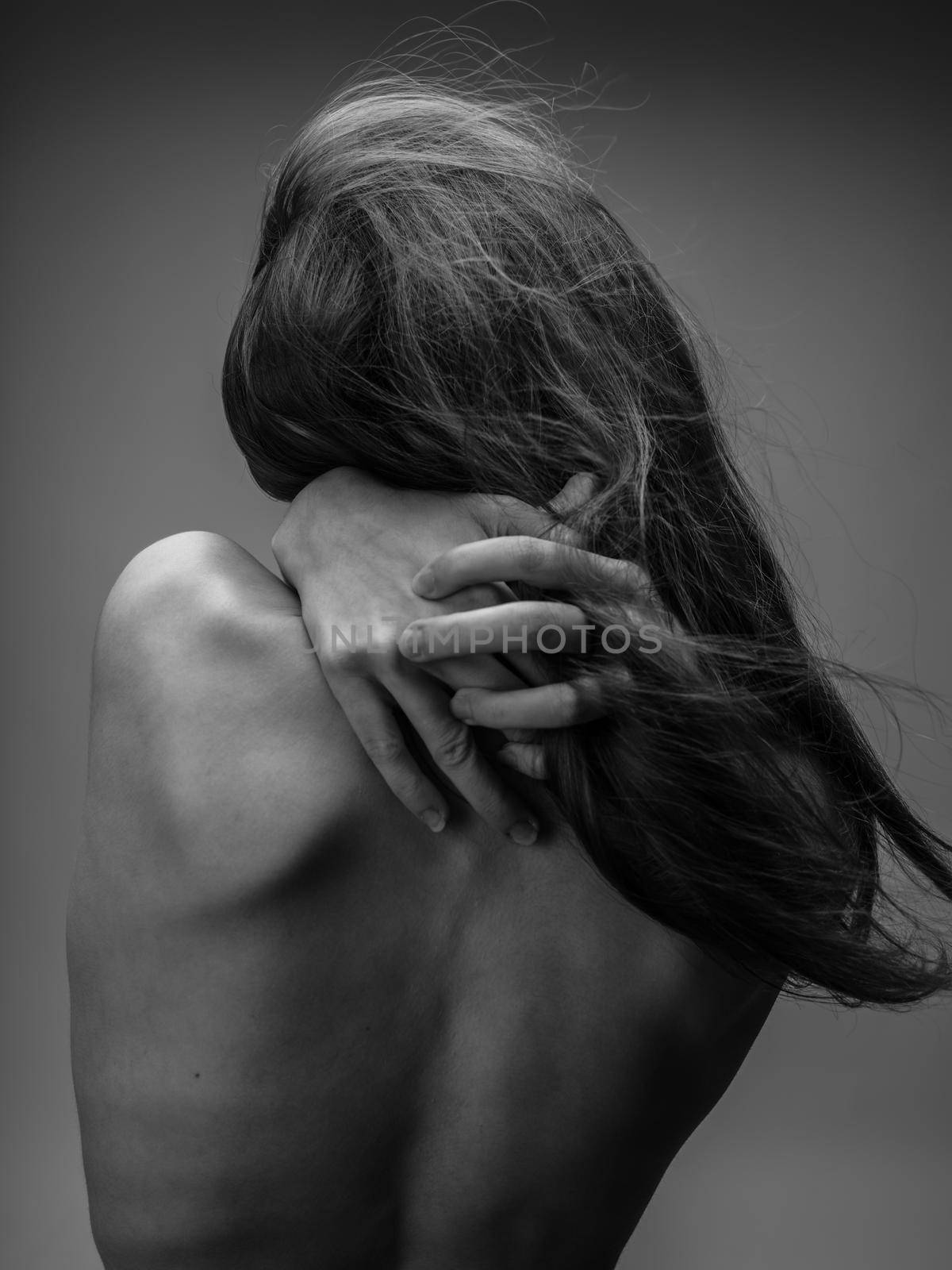 The woman in the gray photograph is touching herself with her bare back by SHOTPRIME
