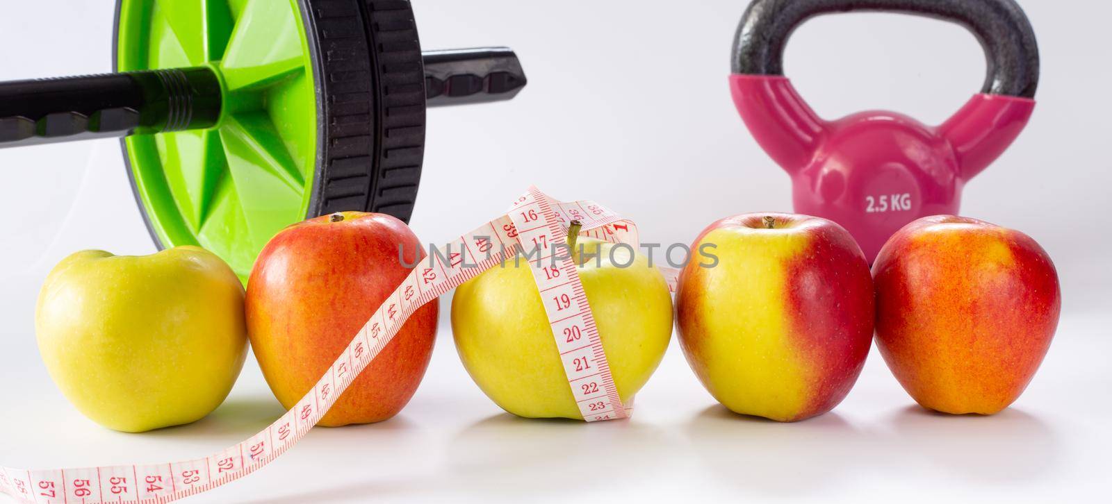 healthy life fitness. Diet and Healthy life Concept. Apples, measure tape, sport home gym equipment kettle bell, ab roller for women diet slimming