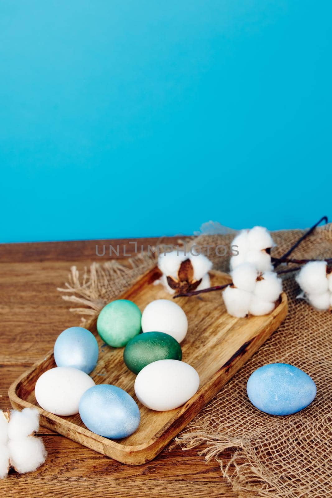 easter eggs wooden trays decoration holiday blue background. High quality photo