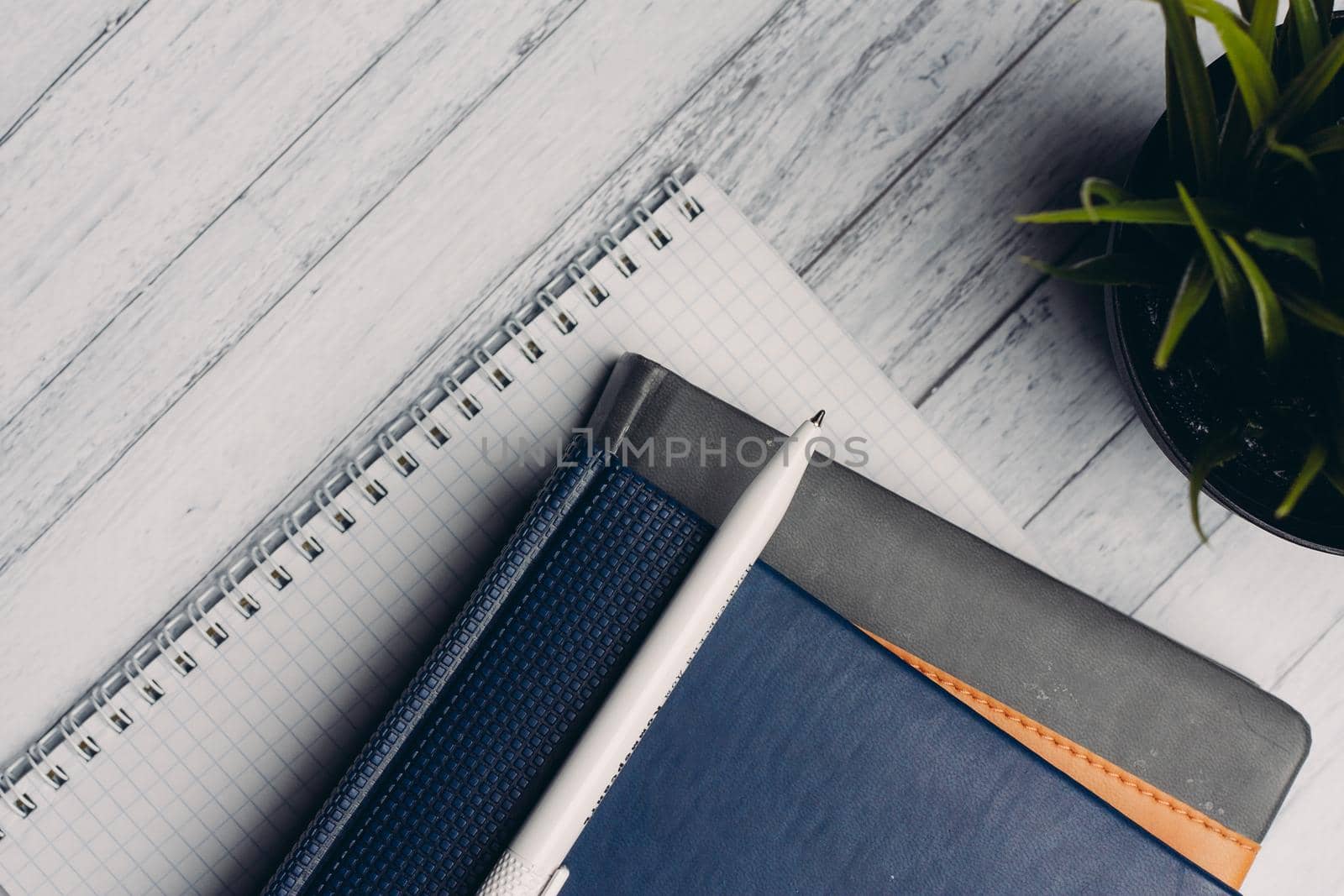 notepads documents desktop office close-up pen objects from above. High quality photo