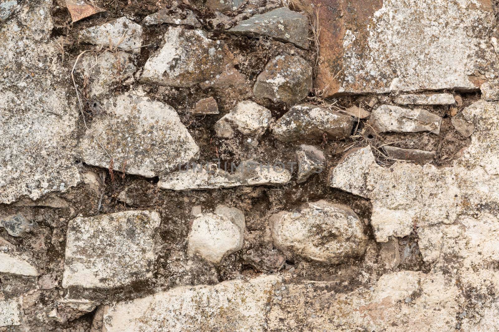 Stone wall of an old house in a village in southern Andalusia in Spain