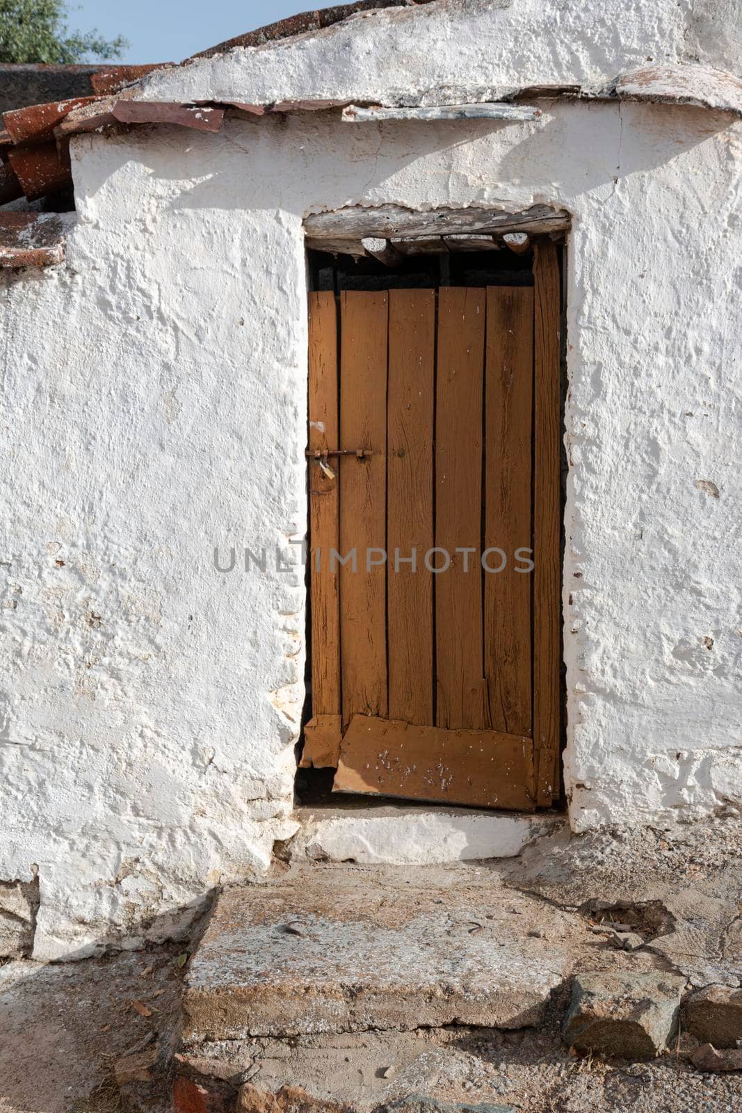 Door of a rustic house in a village by loopneo