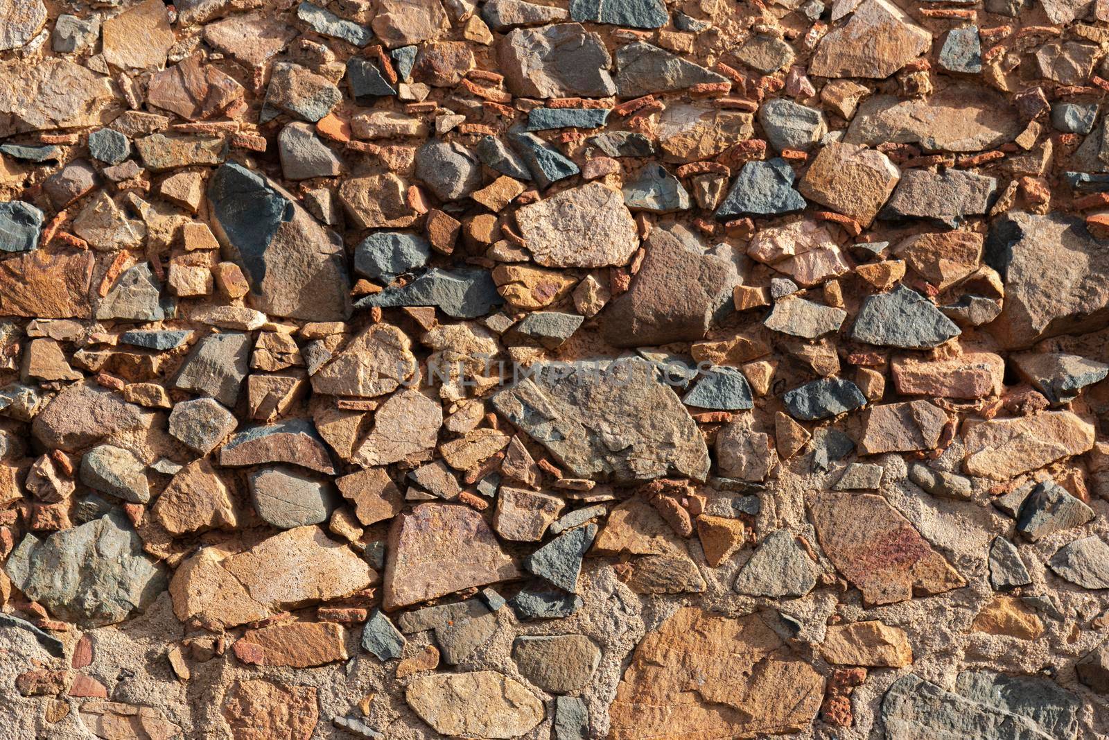 Stone wall of an old house in a village in southern Andalusia in Spain