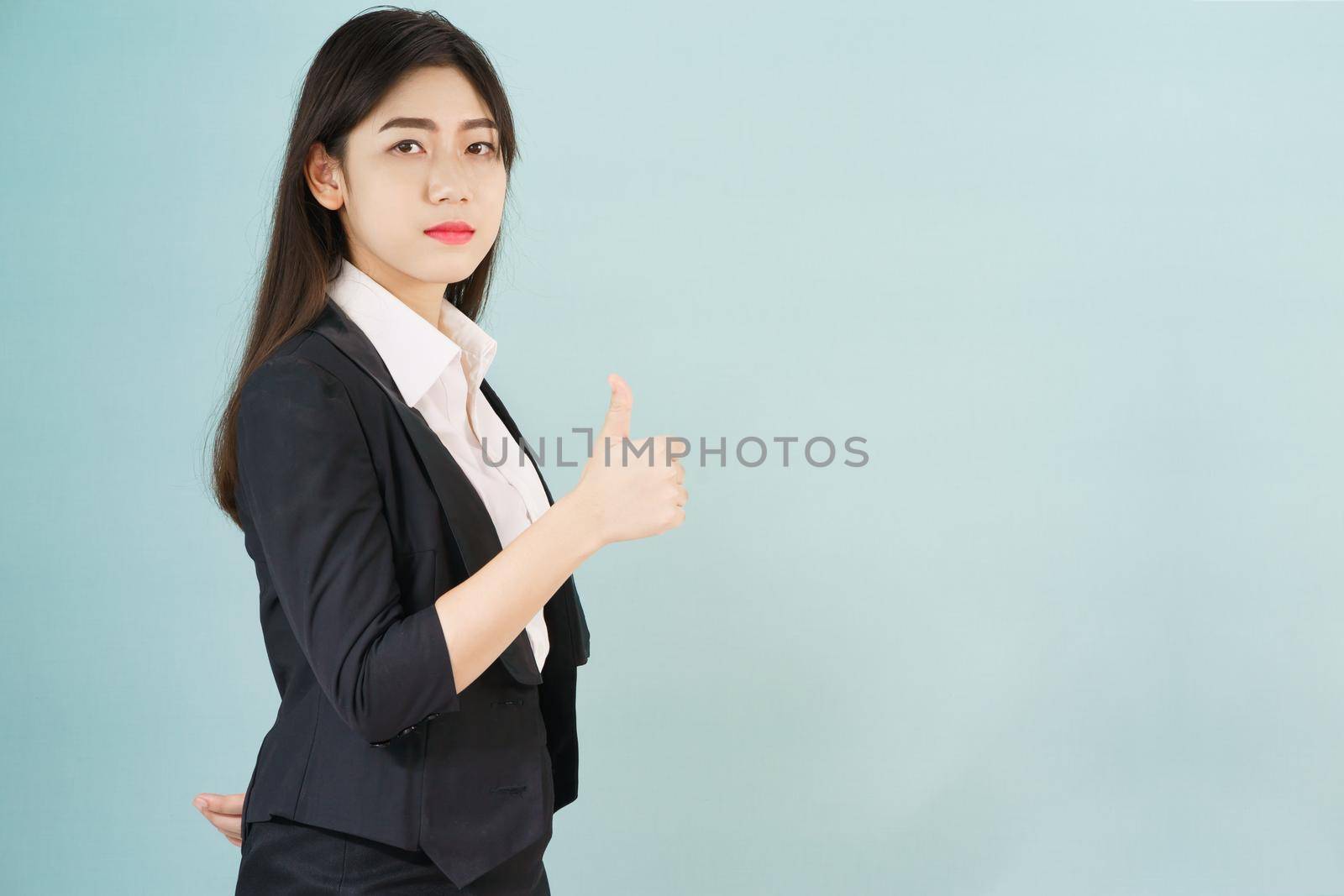 Asian business women in suit and thump up hand sign